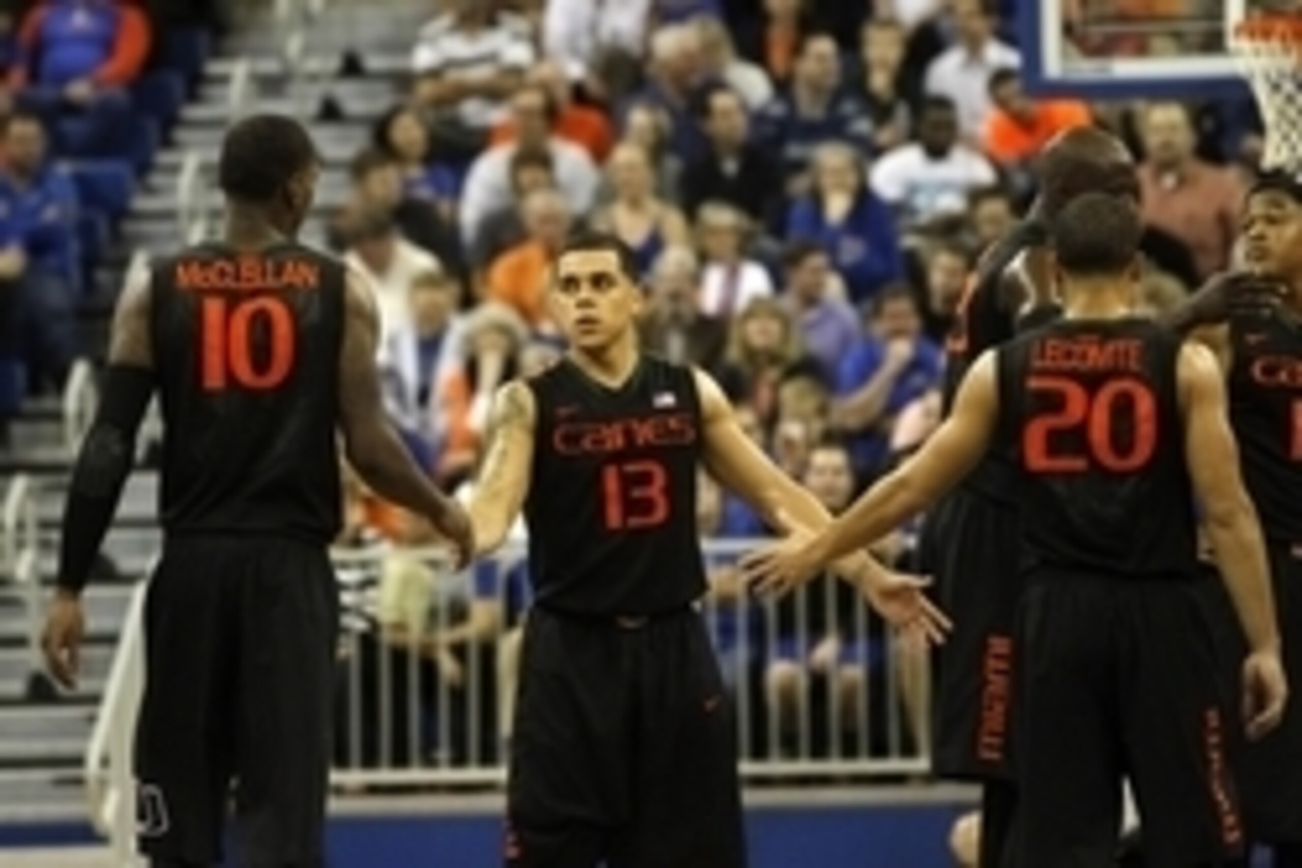 Nov 17, 2014; Gainesville, FL, USA; Miami Hurricanes guard Angel Rodriguez (13), guard Sheldon McClellan (10) and guard Manu Lecomte (20) high five against the Florida Gators during the second half at Stephen C. O'Connell Center. Miami Hurricanes defeated