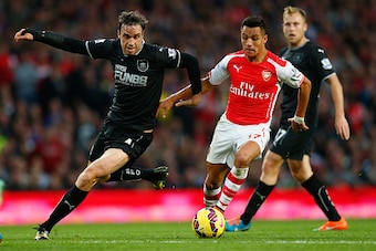 LONDON, ENGLAND - NOVEMBER 01: Michael Duff of Burnley and Alexis Sanchez of Arsenal (R) in action during the Barclays Premier League match between Arsenal and Burnley at Emirates Stadium on November 1, 2014 in London, England.  (Photo by Julian Finney/Ge