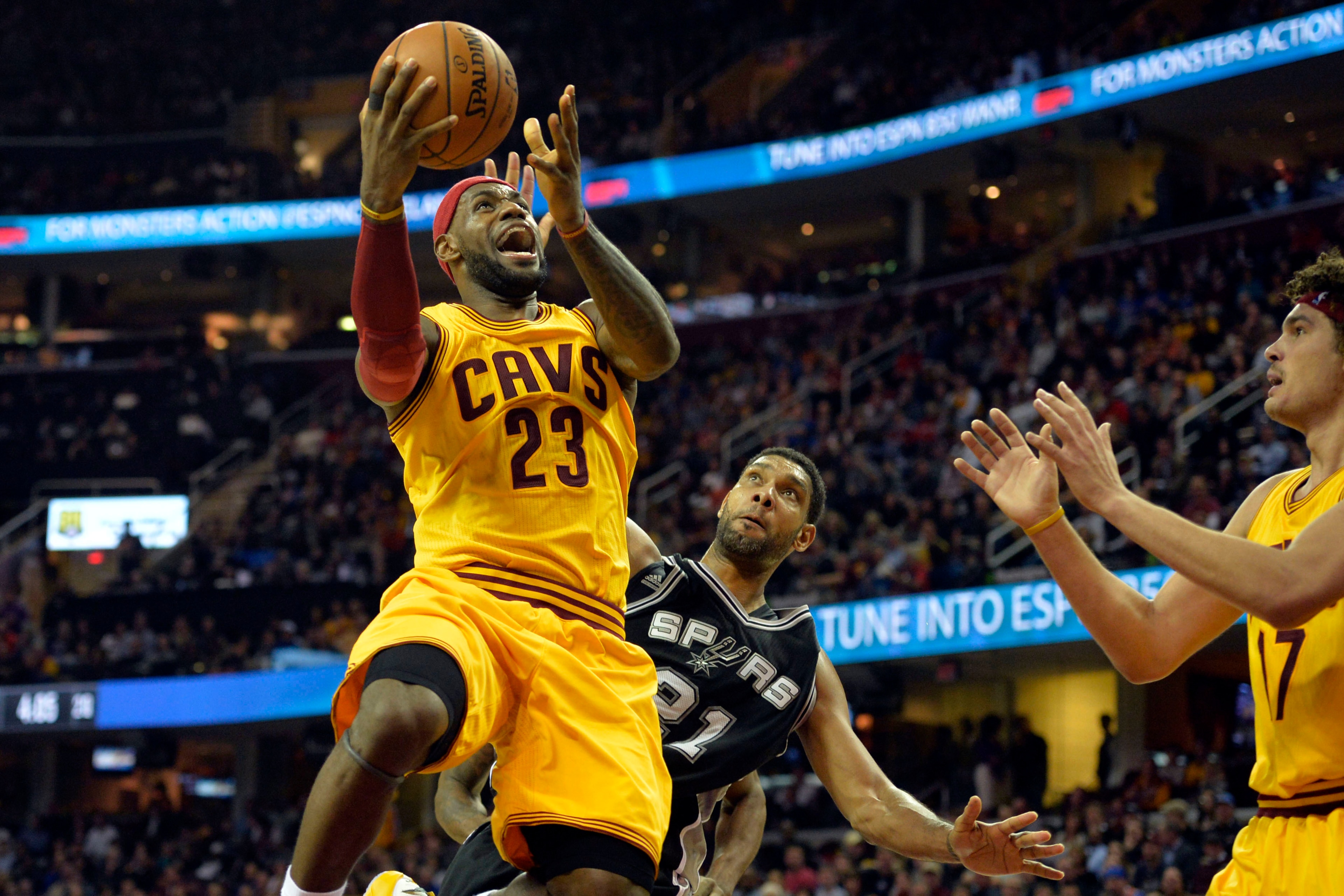 Nov 19, 2014; Cleveland, OH, USA; Cleveland Cavaliers forward LeBron James (23) drives to the basket against San Antonio Spurs forward Tim Duncan (21) in the second quarter at Quicken Loans Arena. Mandatory Credit: David Richard-USA TODAY Sports