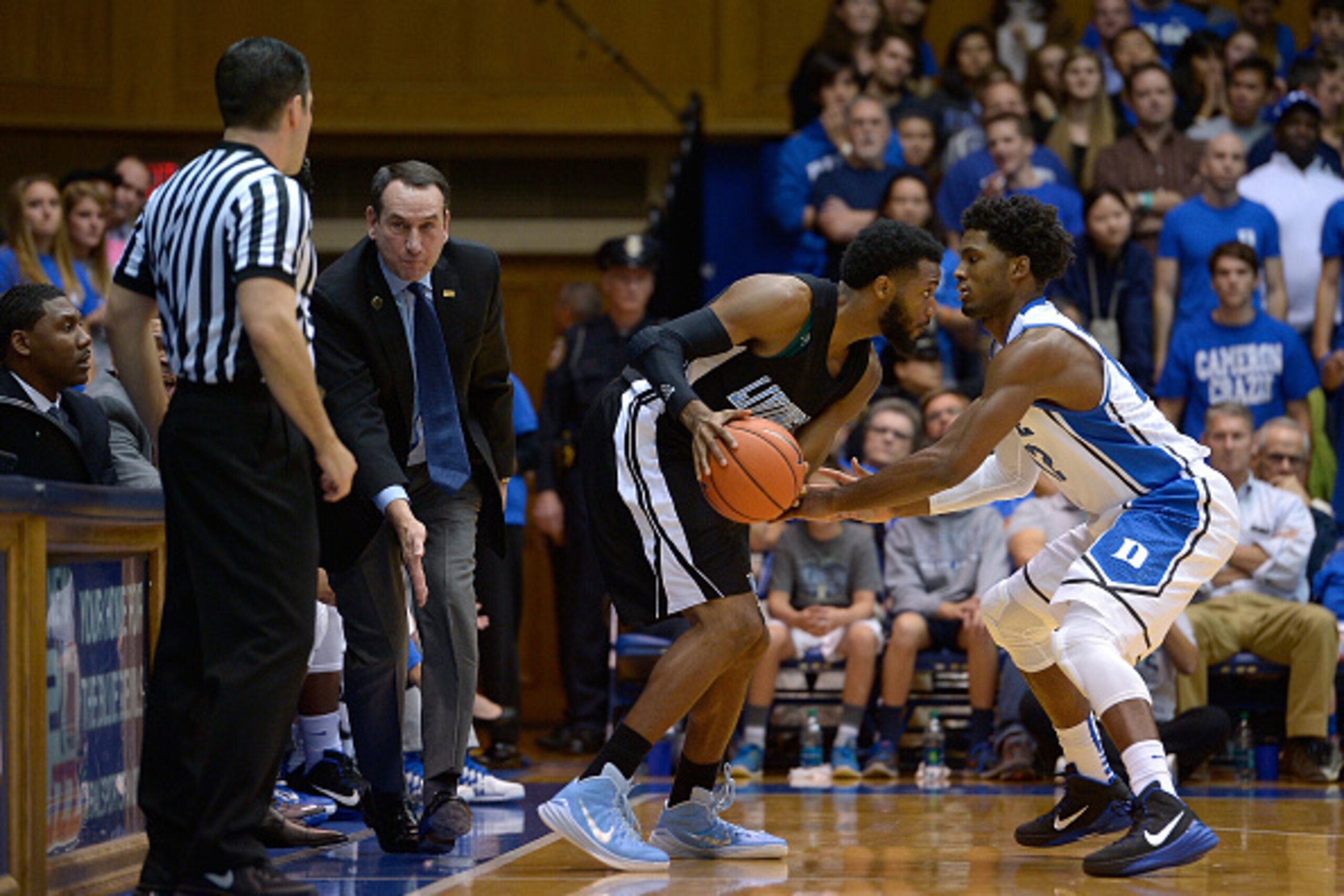DURHAM, NC - NOVEMBER 04:  Head coach Mike Krzyzewski of the Duke Blue Devils  argues with an official that David Williams #12 of the Livingstone College Blue Bears stepped out of bounds while being defended by Justise Winslow #12 during their game at Cam
