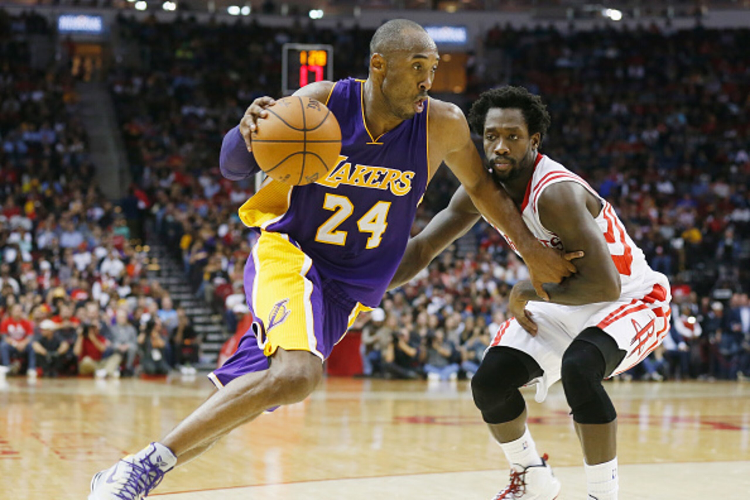 HOUSTON, TX - NOVEMBER 19:  Kobe Bryant #24 of the Los Angeles Lakers drives with the ball against Patrick Beverley #2 of the Houston Rockets during their game at the Toyota Center on November 19, 2014 in Houston, Texas.  NOTE TO USER: User expressly ackn