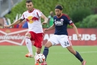 Jun 8, 2014; Foxborough, MA, USA; New York Red Bulls defender Armando (5) and New England Revolution midfielder/forward Lee Nguyen (24) work for the ball in the second half at Gillette Stadium. The New York Red Bulls defeated the New England Revolution 2-