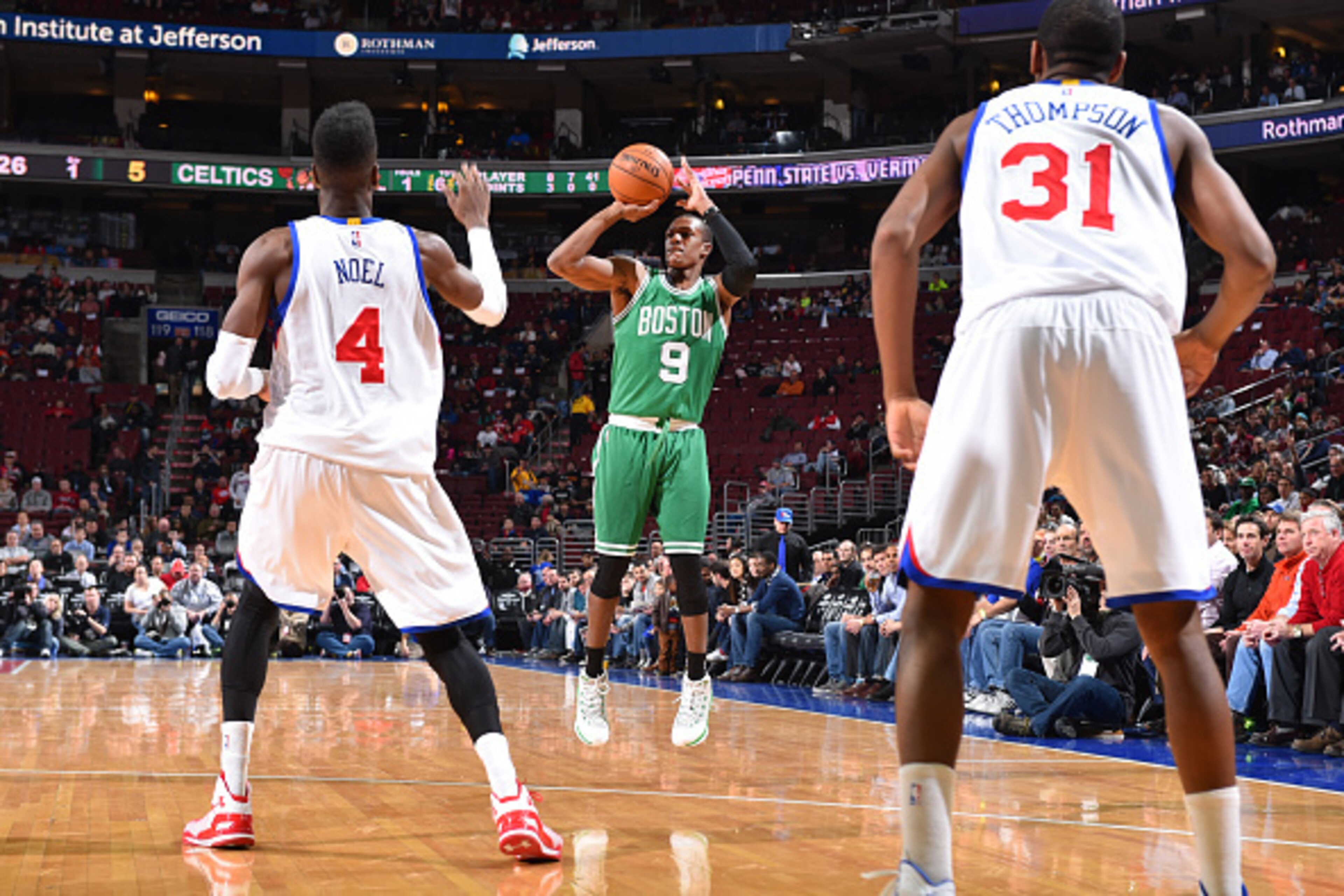 PHILADELPHIA, PA -  NOVEMBER 19: Rajon Rondo #9 of the Boston Celtics shoots against Nerlens Noel #4 and Hollis Thompson #31 of the Philadelphia 76ers during the game on November 19, 2014 at Wells Fargo Center in Philadelphia, Pennsylvania. NOTE TO USER: 