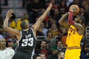 CLEVELAND, OH - NOVEMBER 19: Kyrie Irving #2 of the Cleveland Cavaliers shoots over Boris Diaw #33 of the San Antonio Spurs during the first half at Quicken Loans Arena on November 19, 2014 in Cleveland, Ohio. User expressly acknowledges and agrees that, 