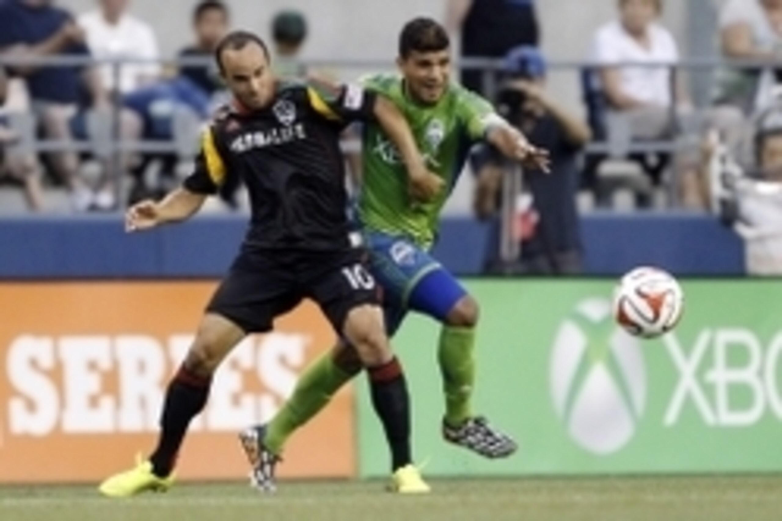 Jul 28, 2014; Seattle, WA, USA; Los Angeles Galaxy midfielder Landon Donovan (10) and Seattle Sounders FC defender DeAndre Yedlin (17) compete for a loose ball during the second half at CenturyLink Field. Mandatory Credit: Joe Nicholson-USA TODAY Sports