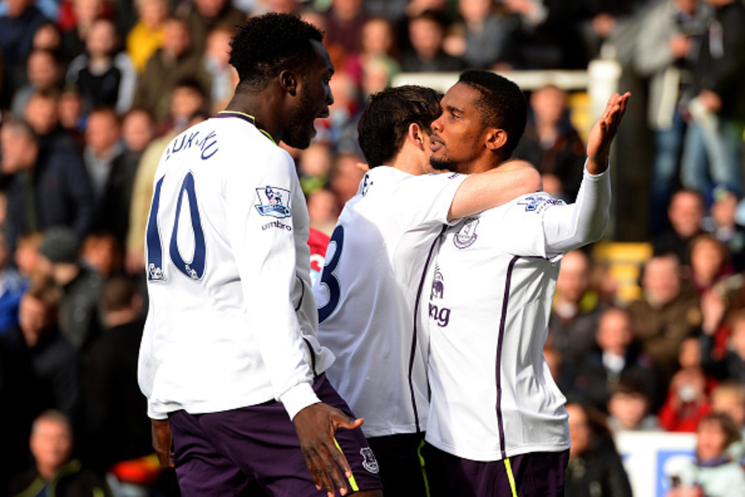 BURNLEY, ENGLAND - OCTOBER 26:  Samuel Eto'o of Everton celebrates with team-mates Leighton Baines and Romelu Lukaku after scoring the opening goal during the Premier League match between Burnley and Everton at Turf Moor on October 26, 2014 in Burnley, En