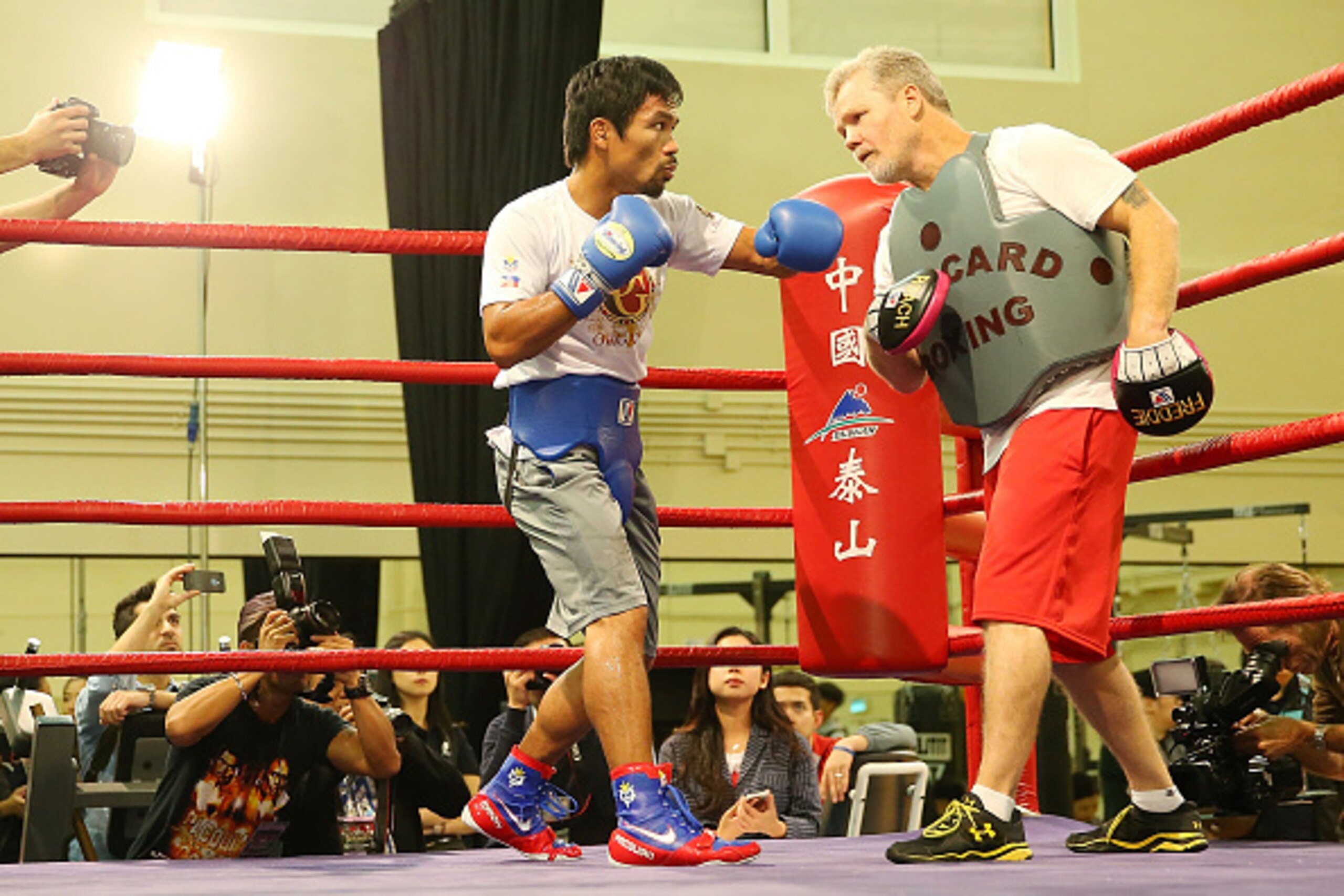 MACAU - NOVEMBER 20:  Manny Pacquiao works the mitts with trainer Freddie Roach during a workout session at The Venetian on November 20, 2014 in Macau, Macau.  (Photo by Chris Hyde/Getty Images)