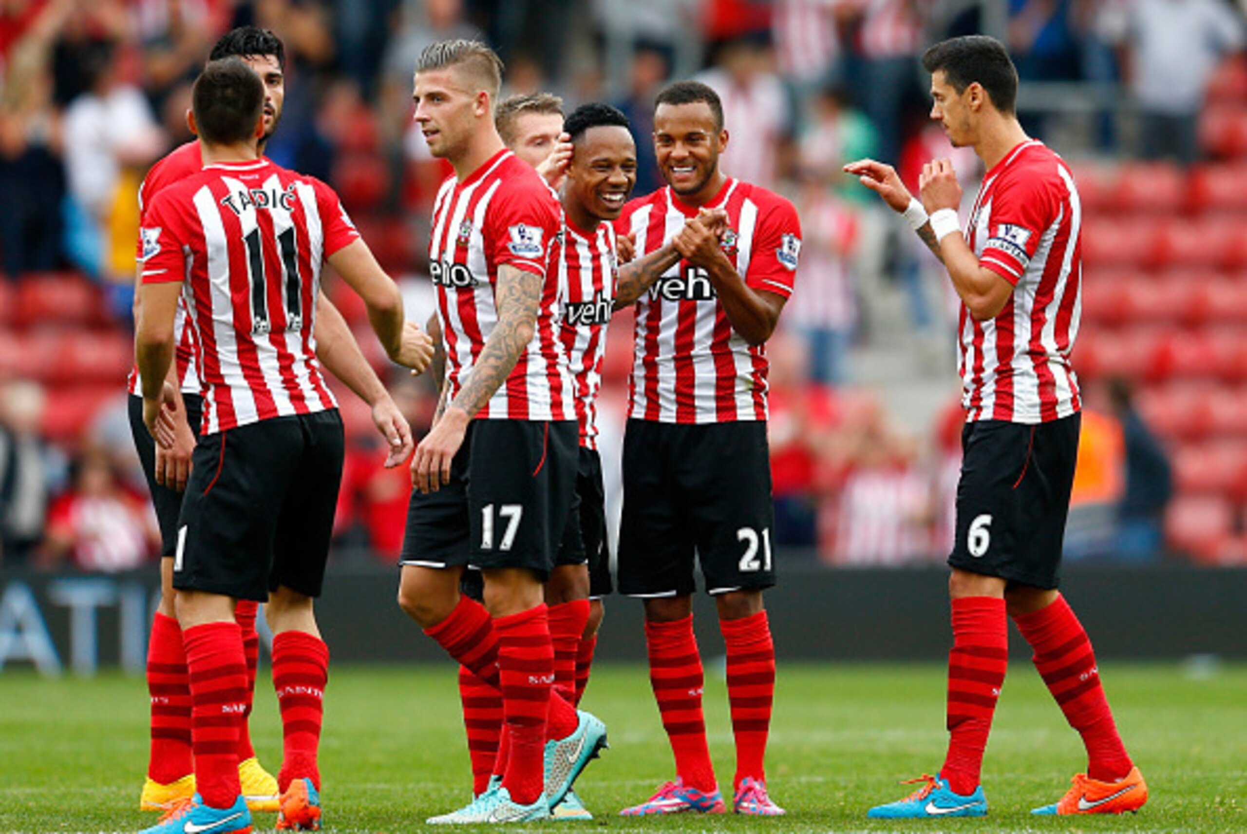 SOUTHAMPTON, ENGLAND - SEPTEMBER 27:  Ryan Bertrand (2nd R) of Southampton celebrates their victory with Nathaniel Clyne (C) and their team-mates during the Barclays Premier League match between Southampton and Queens Park Rangers at St Mary's Stadium on 