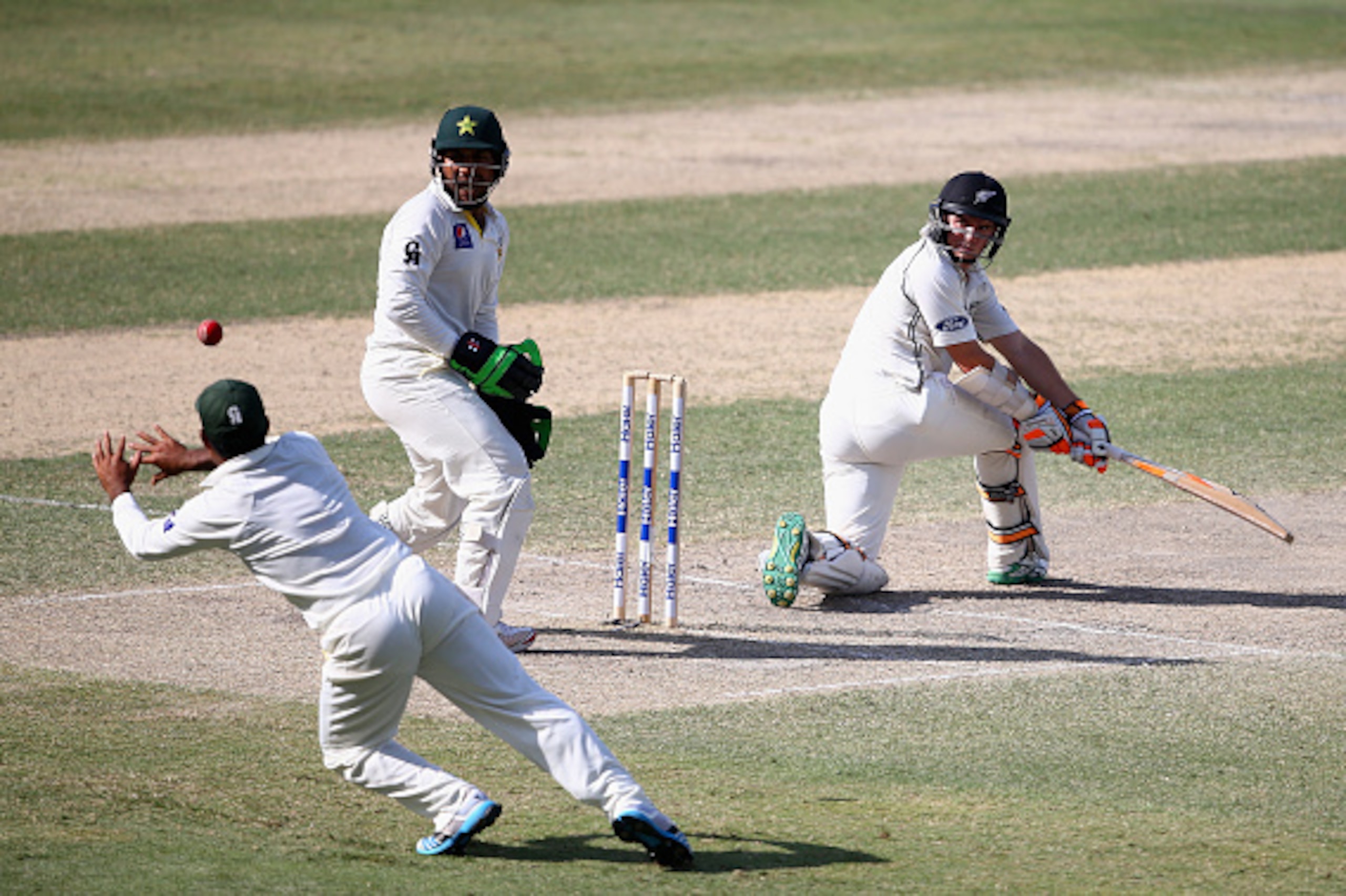 DUBAI, UNITED ARAB EMIRATES - NOVEMBER 20:Tom Latham of New Zealand is caught out by Asad Shafiq of Pakistan during day four of the second test between Pakistan and New Zealand at Dubai International Stadium on November 20, 2014 in Dubai, United Arab Emir