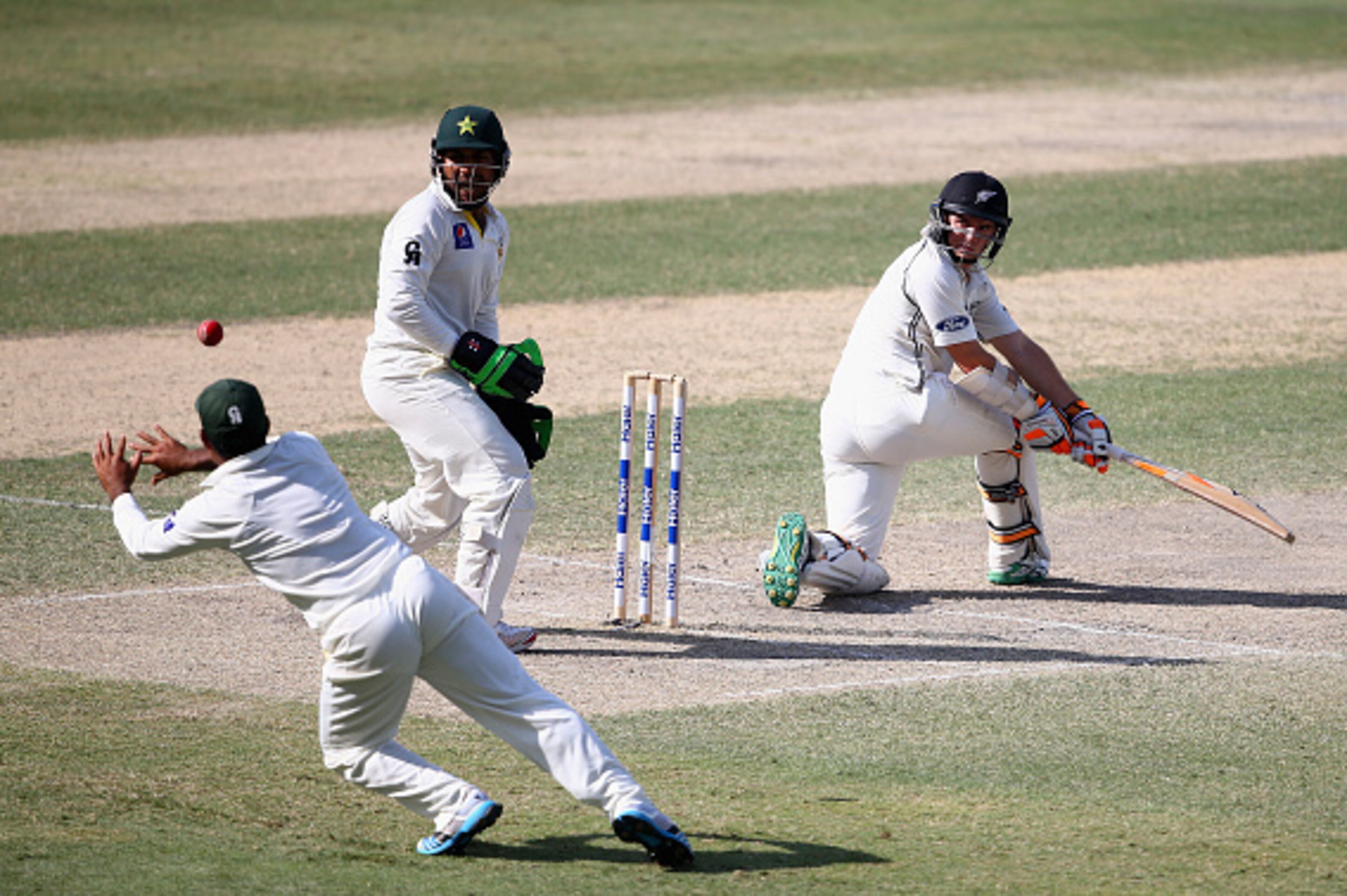 DUBAI, UNITED ARAB EMIRATES - NOVEMBER 20:Tom Latham of New Zealand is caught out by Asad Shafiq of Pakistan during day four of the second test between Pakistan and New Zealand at Dubai International Stadium on November 20, 2014 in Dubai, United Arab Emir