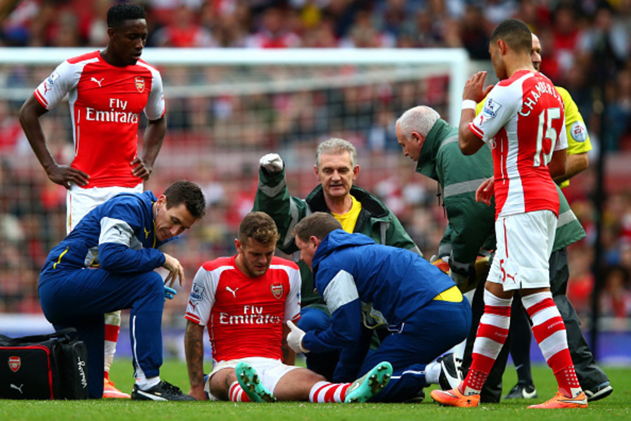 LONDON, ENGLAND - OCTOBER 18:  Jack Wilshere of Arsenal receives treatment after picking up an injury during the Barclays Premier League match between Arsenal and Hull City at Emirates Stadium on October 18, 2014 in London, England.  (Photo by Clive Rose/