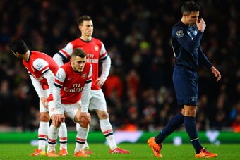LONDON, ENGLAND - FEBRUARY 12:  Jack Wilshere (L) of Arsenal and Robin van Persie (R) of Manchester United react during the Barclays Premier League match between Arsenal and Manchester United at the Emirates Stadium on February 12, 2014 in London, England