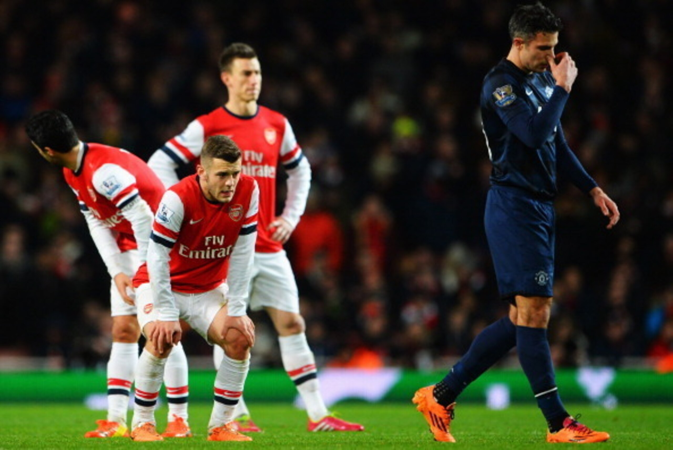 LONDON, ENGLAND - FEBRUARY 12: Jack Wilshere (L) of Arsenal and Robin van Persie (R) of Manchester United react during the Barclays Premier League match between Arsenal and Manchester United at the Emirates Stadium on February 12, 2014 in London, England LONDON, ENGLAND - FEBRUARY 12: Jack Wilshere (L) of Arsenal and Robin van Persie (R) of Manchester United react during the Barclays Premier League match between Arsenal and Manchester United at the Emirates Stadium on February 12, 2014 in London, England