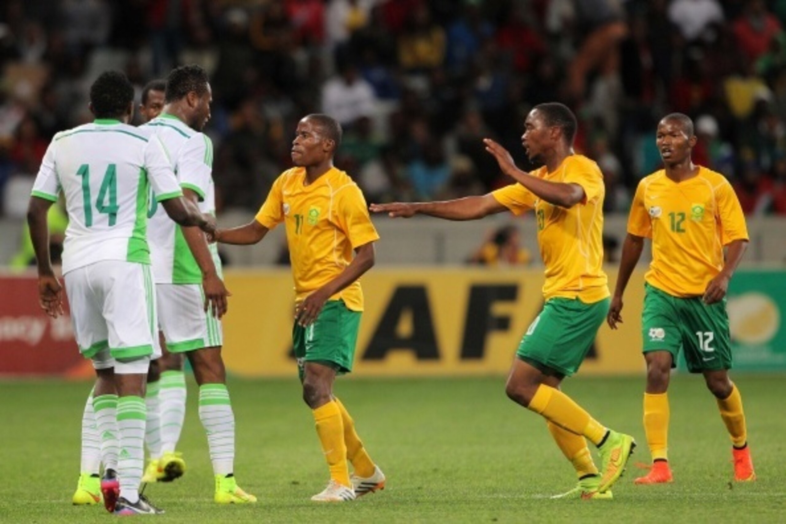 CAPE TOWN, SOUTH AFRICA - SEPTEMBER 10: Obi Mikel of Nigeria and Thabo Matlaba of South Africa having words during the Orange AFCON, Morocco 2015 Final Round Qualifier match between South Africa and Nigeria at Cape Town Stadium on September 10, 2014 in Ca