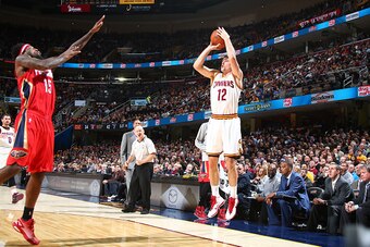CLEVELAND, OH - NOVEMBER 10:  Joe Harris #12 of the Cleveland Cavaliers shoots against John Salmons #15 of the New Orleans Pelicans on November 10, 2014 at Quicken Loans Arena in Cleveland. Ohio.  NOTE TO USER: User expressly acknowledges and agrees that,