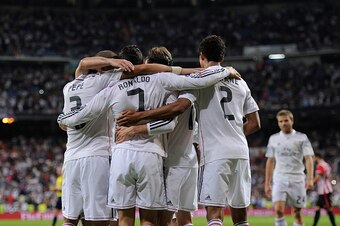 MADRID, SPAIN - OCTOBER 05:  Cristiano Ronaldo of Real Madrid celebrates with teammates after scoring his team's 5th and his third goal against Club Athletic during the La Liga match between Real Madrid CF and Athletic Club at Estadio Santiago Bernabeu on