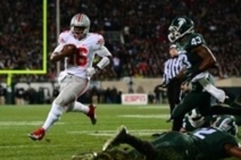 Nov 8, 2014; East Lansing, MI, USA; Ohio State Buckeyes quarterback J.T. Barrett (16) runs the ball into the end zone for a touchdown during the first quarter against the Michigan State Spartans at Spartan Stadium. Mandatory Credit: Andrew Weber-USA TODAY