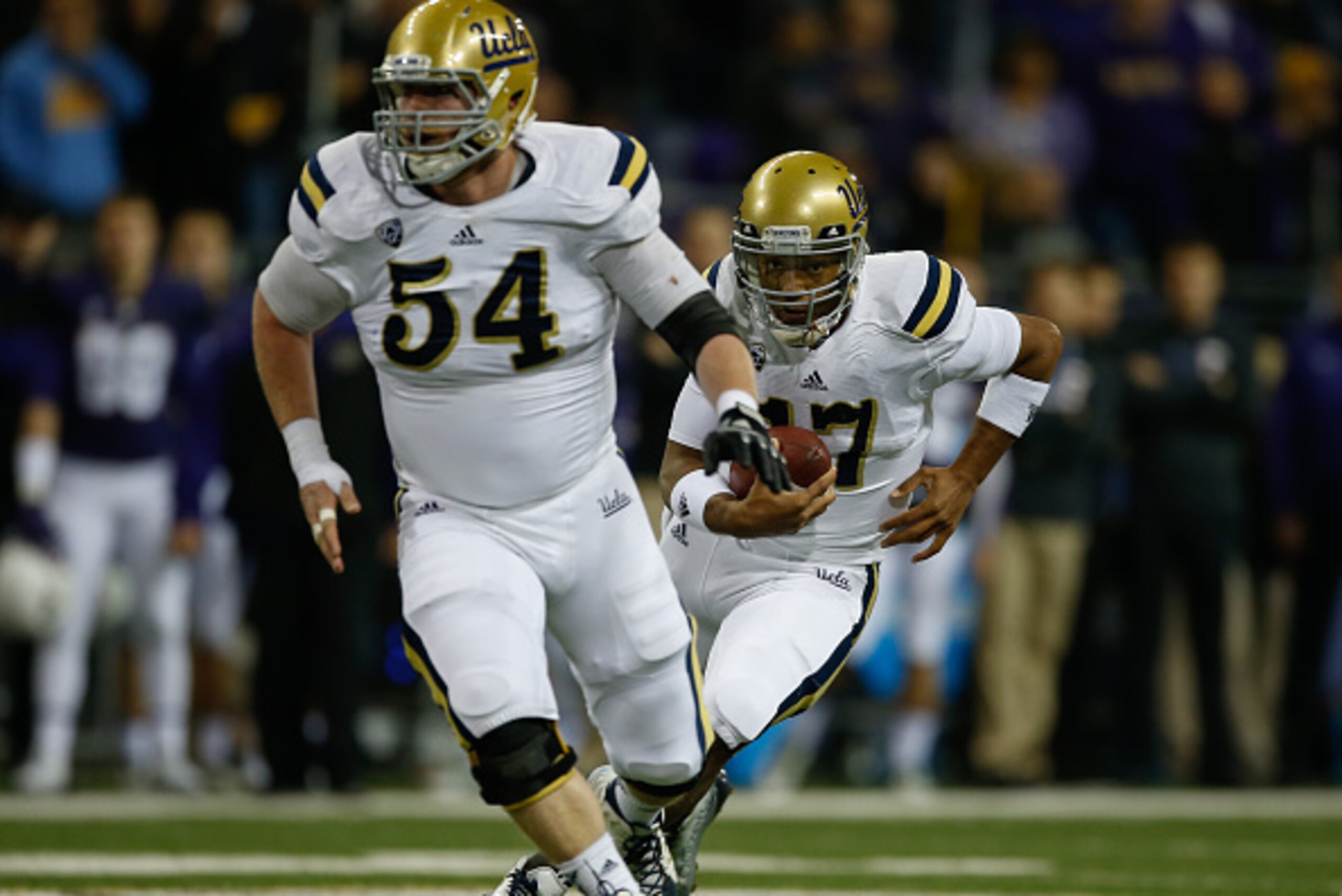 SEATTLE, WA - NOVEMBER 08:  Quarterback Brett Hundley #17 of the UCLA Bruins rushes behind the block of Jake Brendel #54 against the Washington Huskies on November 8, 2014 at Husky Stadium in Seattle, Washington.  (Photo by Otto Greule Jr/Getty Images)
