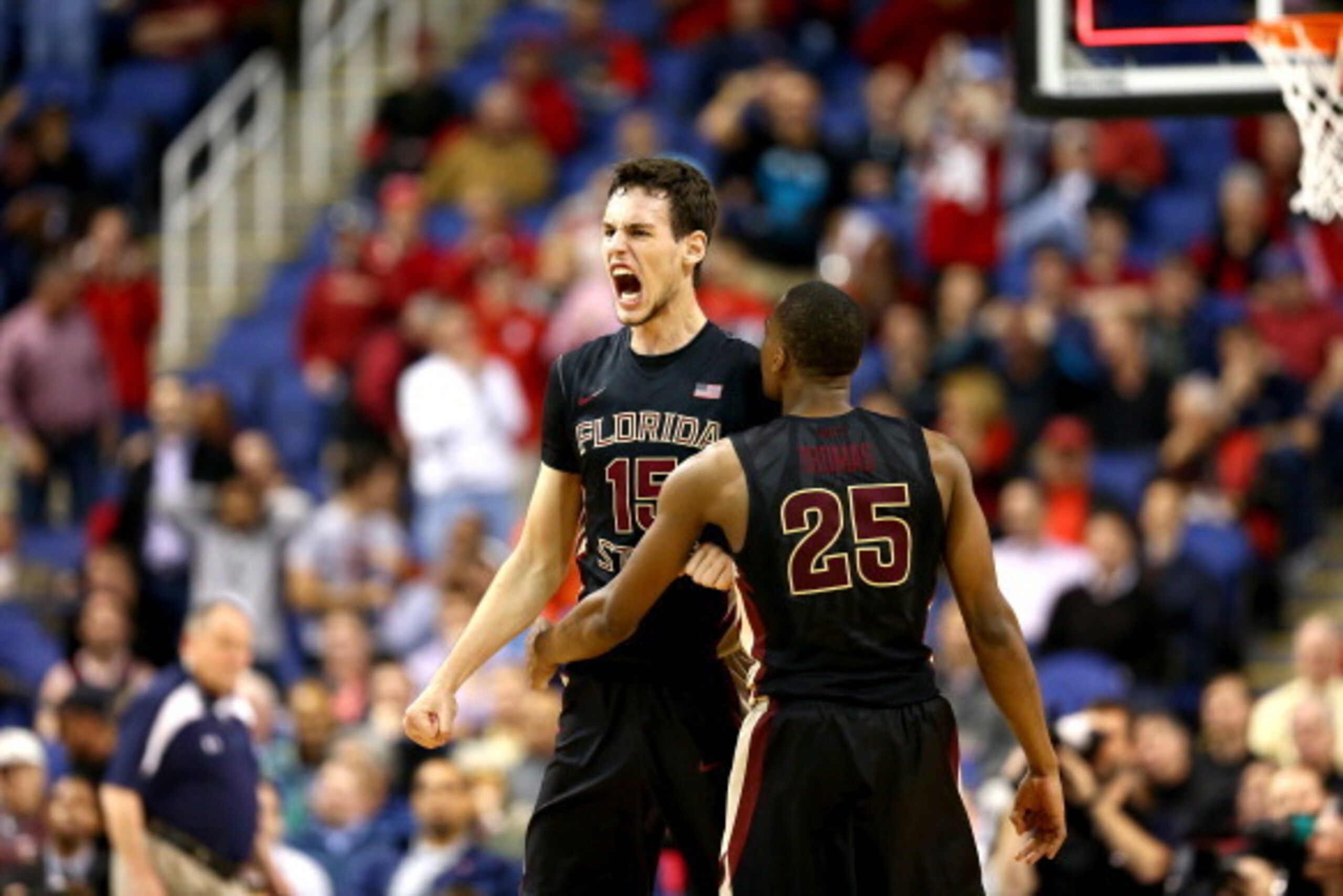 GREENSBORO, NC - MARCH 13:  Boris Bojanovsky #15 of the Florida State Seminoles reacts afer making the game winning dunk with teammate Aaron Thomas #25 to defeat the Terrapins 67-65 during the second round of the 2014 Men's ACC Basketball Tournament at Gr