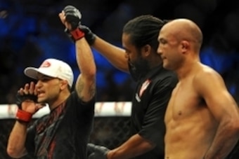 Jul 6, 2014; Las Vegas, NV, USA; Frankie Edgar (red gloves) is named victor over B.J. Penn (blue gloves) following a featherweight bout at Mandalay Bay Events Center. Mandatory Credit: Stephen R. Sylvanie-USA TODAY Sports