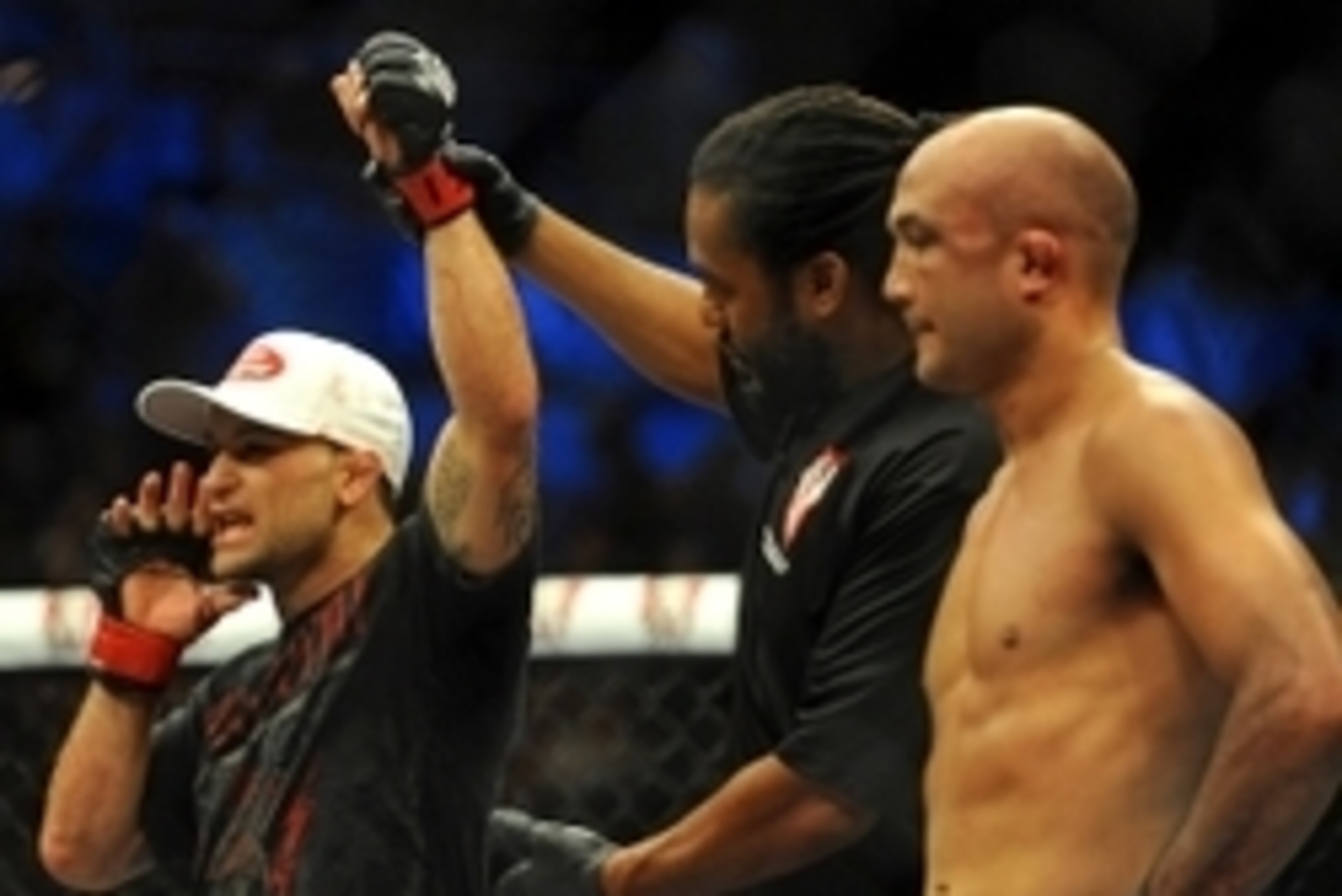 Jul 6, 2014; Las Vegas, NV, USA; Frankie Edgar (red gloves) is named victor over B.J. Penn (blue gloves) following a featherweight bout at Mandalay Bay Events Center. Mandatory Credit: Stephen R. Sylvanie-USA TODAY Sports