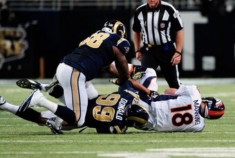 Nov 16, 2014; St. Louis, MO, USA; St. Louis Rams defensive tackle Aaron Donald (99) sacks Denver Broncos quarterback Peyton Manning (18) during the second half at the Edward Jones Dome. The Rams won 22-7. Mandatory Credit: Jeff Curry-USA TODAY Sports