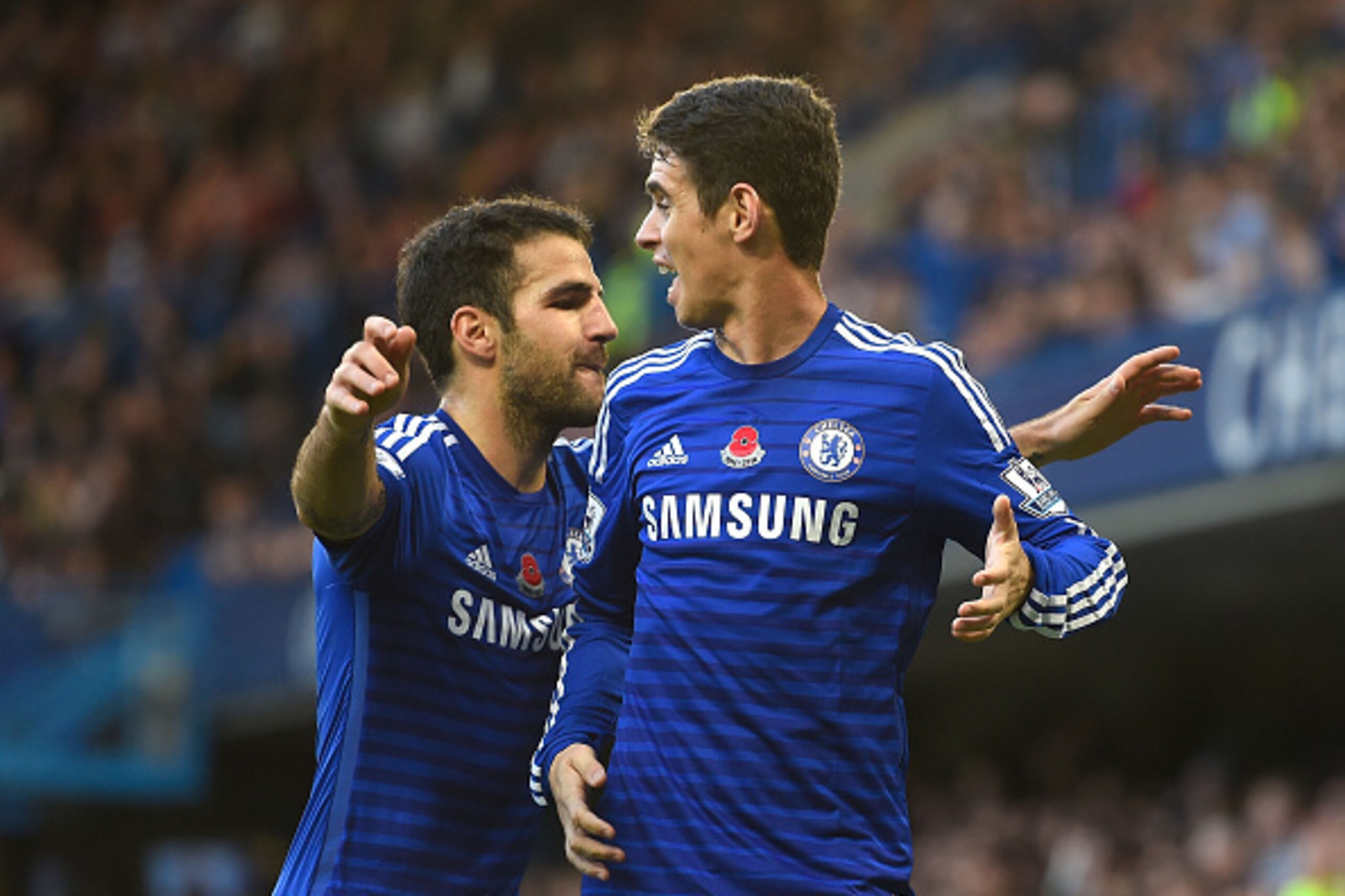 LONDON, ENGLAND - NOVEMBER 01:  Oscar of Chelsea celebrates his goal with Cesc Fabregas during the Barclays Premier League match between Chelsea and Queens Park Rangers at Stamford Bridge on November 1, 2014 in London, England.  (Photo by Mike Hewitt/Gett