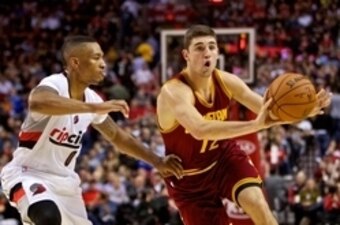 Nov 4, 2014; Portland, OR, USA; Cleveland Cavaliers guard Joe Harris (12) passes away from Portland Trail Blazers guard Damian Lillard (0) during the fourth quarter at the Moda Center. Mandatory Credit: Craig Mitchelldyer-USA TODAY Sports