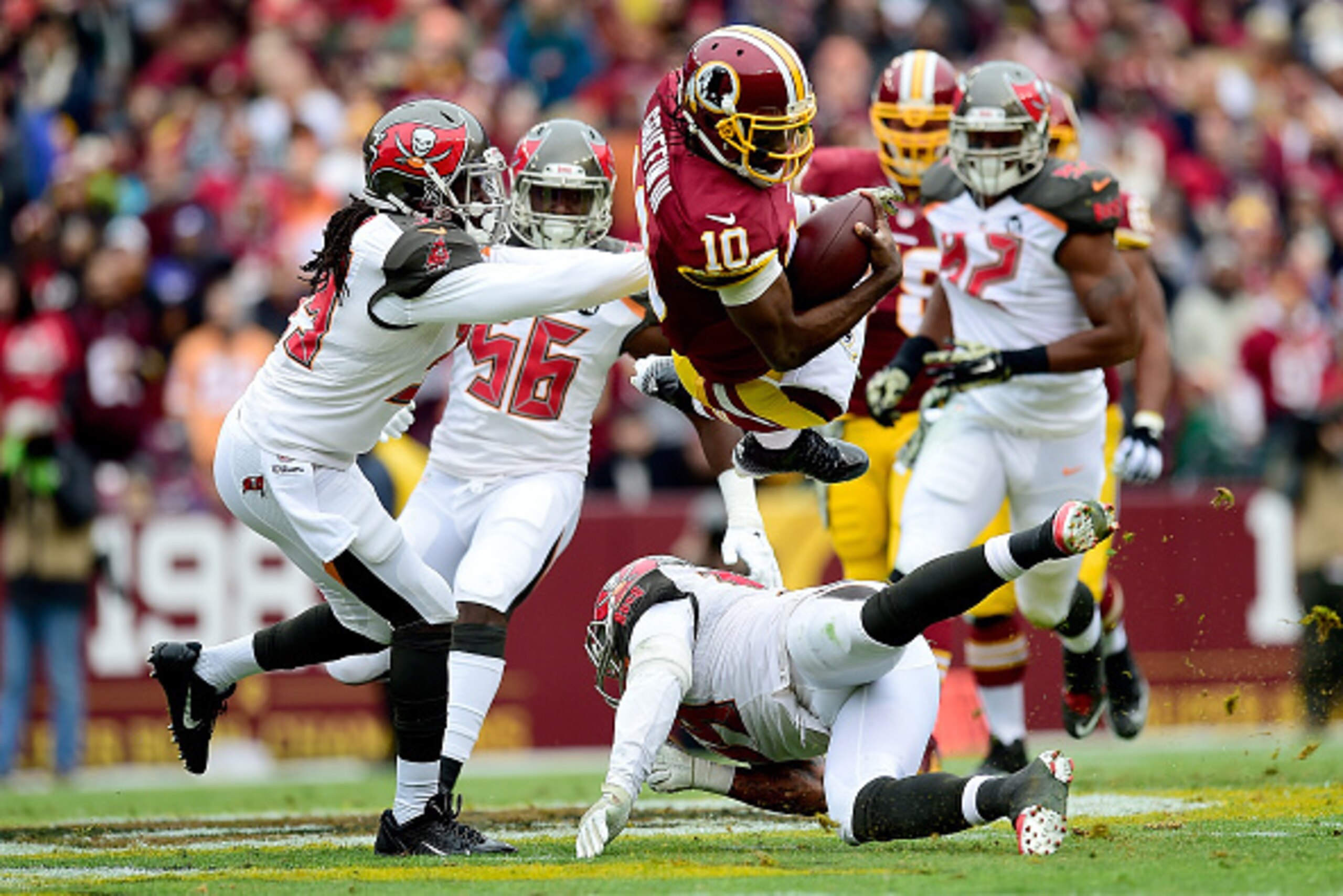 LANDOVER, MD - NOVEMBER 16:  Quarterback Robert Griffin III #10 of the Washington Redskins takes a second quarter hit from defensive back Brandon Dixon #39 of the Tampa Bay Buccaneers at FedExField on November 16, 2014 in Landover, Maryland.  (Photo by Pa