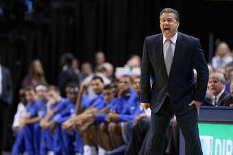 INDIANAPOLIS, IN - NOVEMBER 18:  John Calipari the head coach of the Kentucky Wildcats gives instructions to his team during the game against the Kansas Jayhwaks in the State Farm Champions Classic at Bankers Life Fieldhouse on November 18, 2014 in Indian