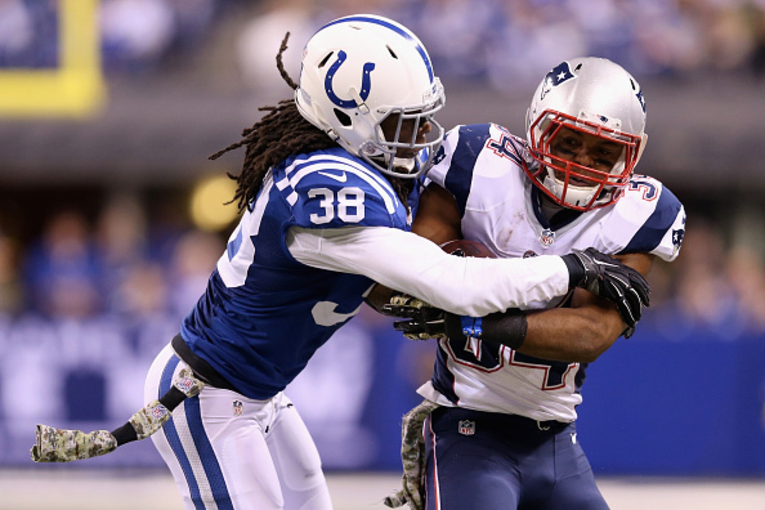 INDIANAPOLIS, IN - NOVEMBER 16:  Shane Vereen #34 of the New England Patriots fights against Sergio Brown #38 of the Indianapolis Colts during the third quarter of the game at Lucas Oil Stadium on November 16, 2014 in Indianapolis, Indiana.  (Photo by And