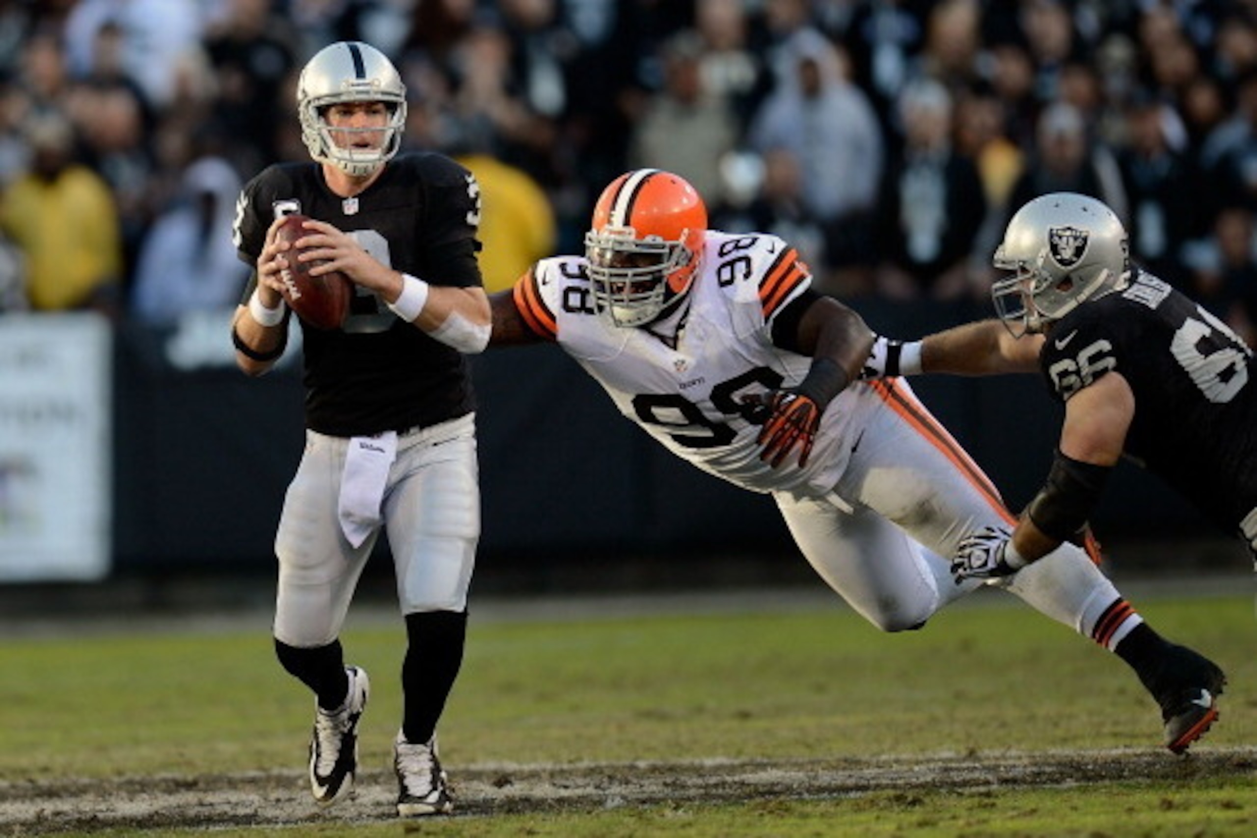 OAKLAND, CA - DECEMBER 02:  Carson Palmer #3 of the Oakland Raiders scrambles away from the presure of Phil Taylor #98 of the Cleveland Browns during the third quarter at Oakland-Alameda County Coliseum on December 2, 2012 in Oakland, California.  (Photo 