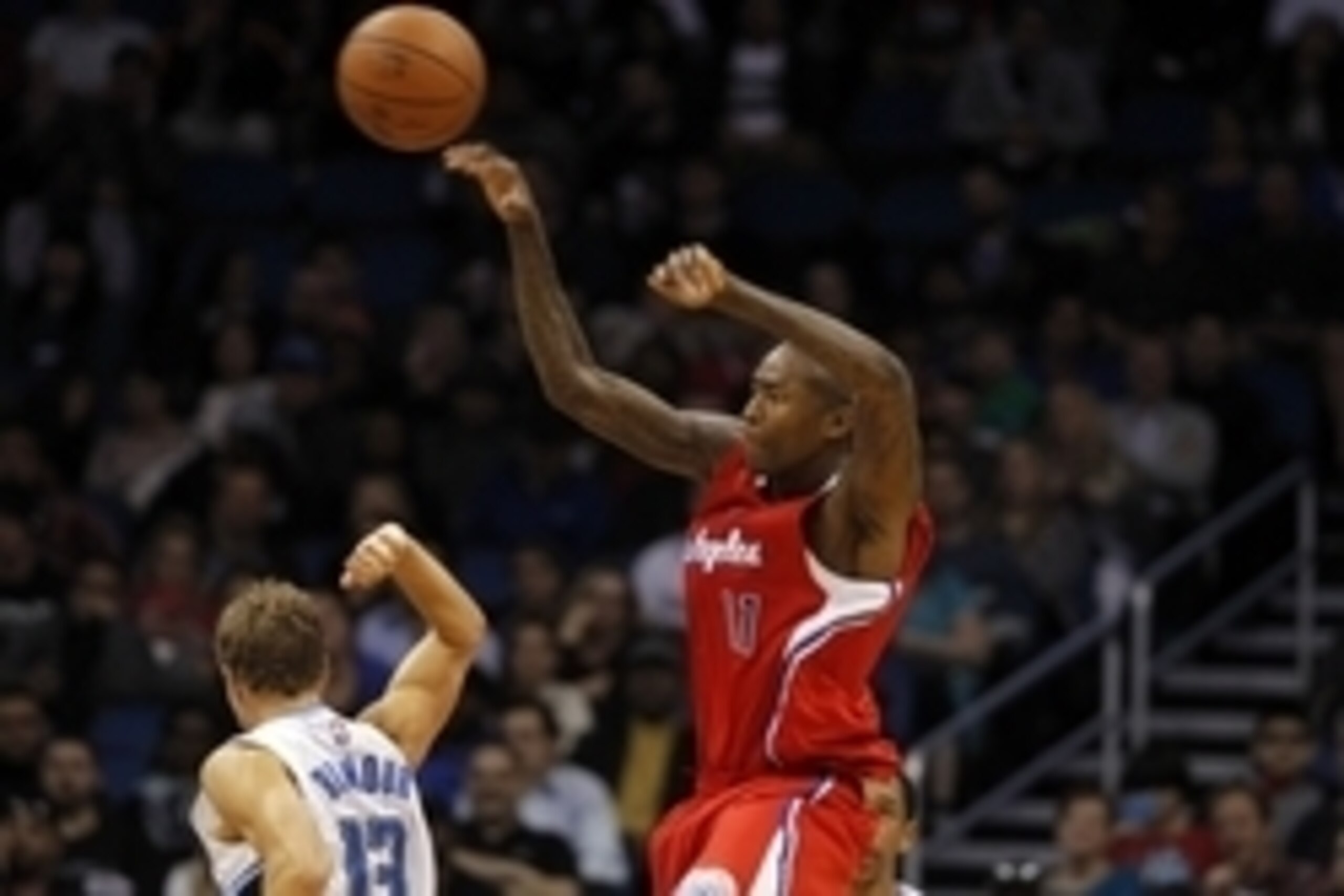 Nov 19, 2014; Orlando, FL, USA; Los Angeles Clippers guard Jamal Crawford (11) passes the ball over Orlando Magic guard Luke Ridnour (13) during the second half at Amway Center. Los Angeles Clippers defeated the Orlando Magic 114-90. Mandatory Credit: Kim