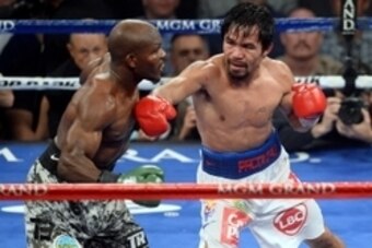 Apr 12, 2014; Las Vegas, NV, USA; Timothy Bradley (green gloves) and Manny Pacquiao (red gloves) box during their WBO World Welterweight Title bout at MGM Grand Garden Arena. Pacquiao won via unanimous decision. Mandatory Credit: Joe Camporeale-USA TODAY 