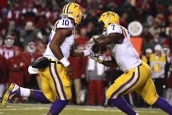 Nov 15, 2014; Fayetteville, AR, USA; LSU Tigers quarterback Anthony Jennings (10) hands the ball off to LSU Tigers running back Leonard Fournette (7) during the first half at Donald W. Reynolds Razorback Stadium. Mandatory Credit: Jasen Vinlove-USA TODAY