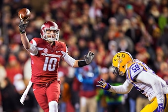 FAYETTEVILLE, AR - NOVEMBER 15:  Brandon Allen #10 of the Arkansas Razorbacks throws a pass under pressure in the first quarter from Jermauria Rasco #59 of the LSU Tigers at Razorback Stadium on November 15, 2014 in Fayetteville, Arkansas.  (Photo by Wesl
