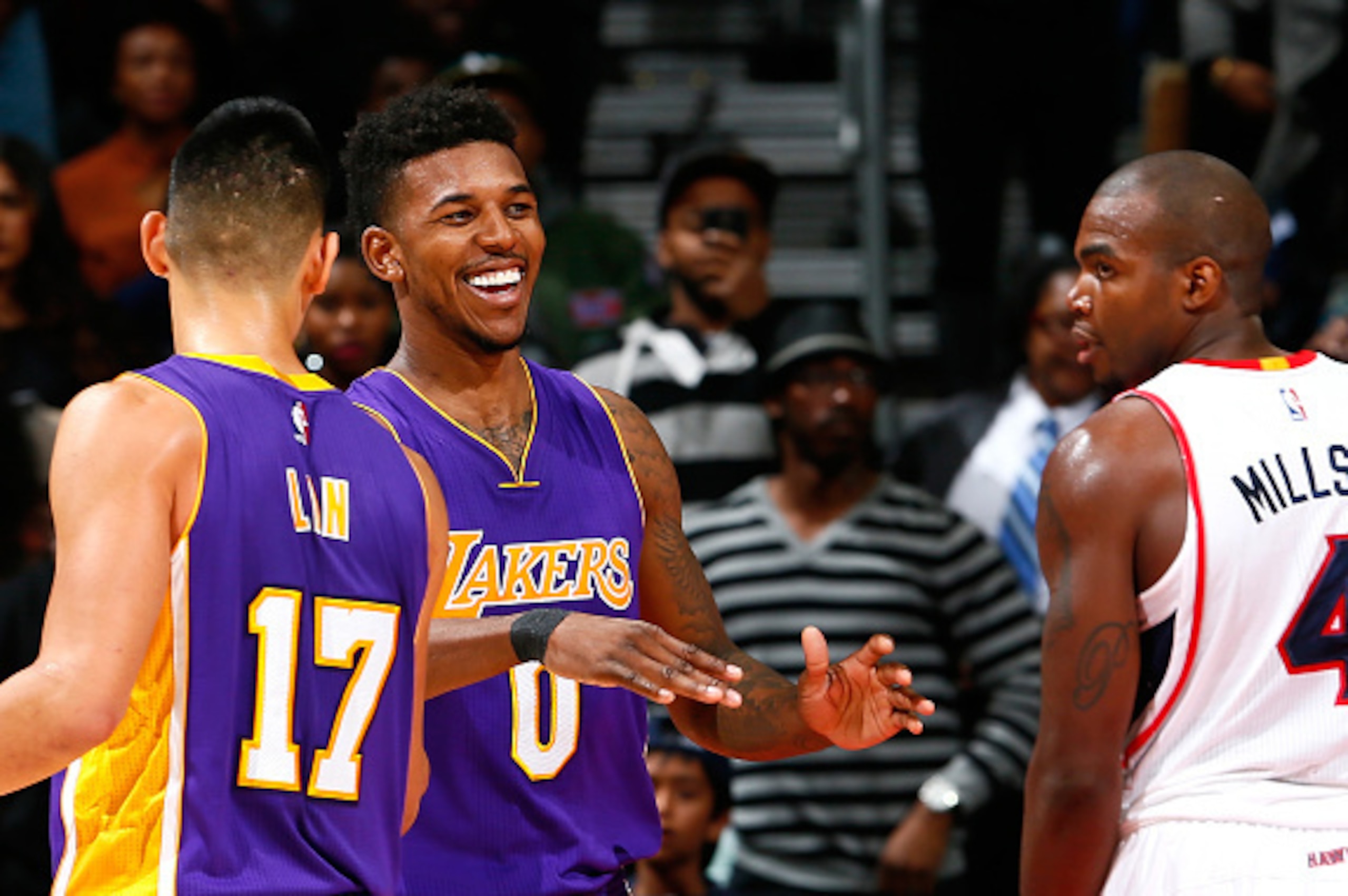 ATLANTA, GA - NOVEMBER 18: Nick Young #0 of the Los Angeles Lakers reacts with Jeremy Lin #17 after drawing a foul on a three-pointer attempt against the Atlanta Hawks at Philips Arena on November 18, 2014 in Atlanta, Georgia. NOTE TO USER: User express ATLANTA, GA - NOVEMBER 18: Nick Young #0 of the Los Angeles Lakers reacts with Jeremy Lin #17 after drawing a foul on a three-pointer attempt against the Atlanta Hawks at Philips Arena on November 18, 2014 in Atlanta, Georgia. NOTE TO USER: User express