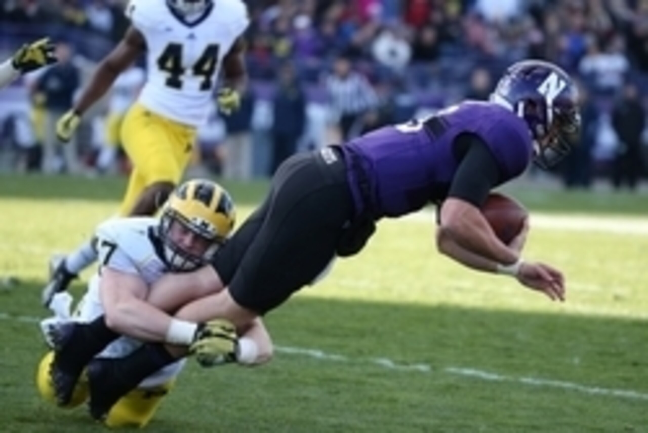 Nov 8, 2014; Evanston, IL, USA; Northwestern Wildcats quarterback Trevor Siemian (13) is tackled by Michigan Wolverines linebacker Jake Ryan (47) in the first half at Ryan Field. Mandatory Credit: Caylor Arnold-USA TODAY Sports