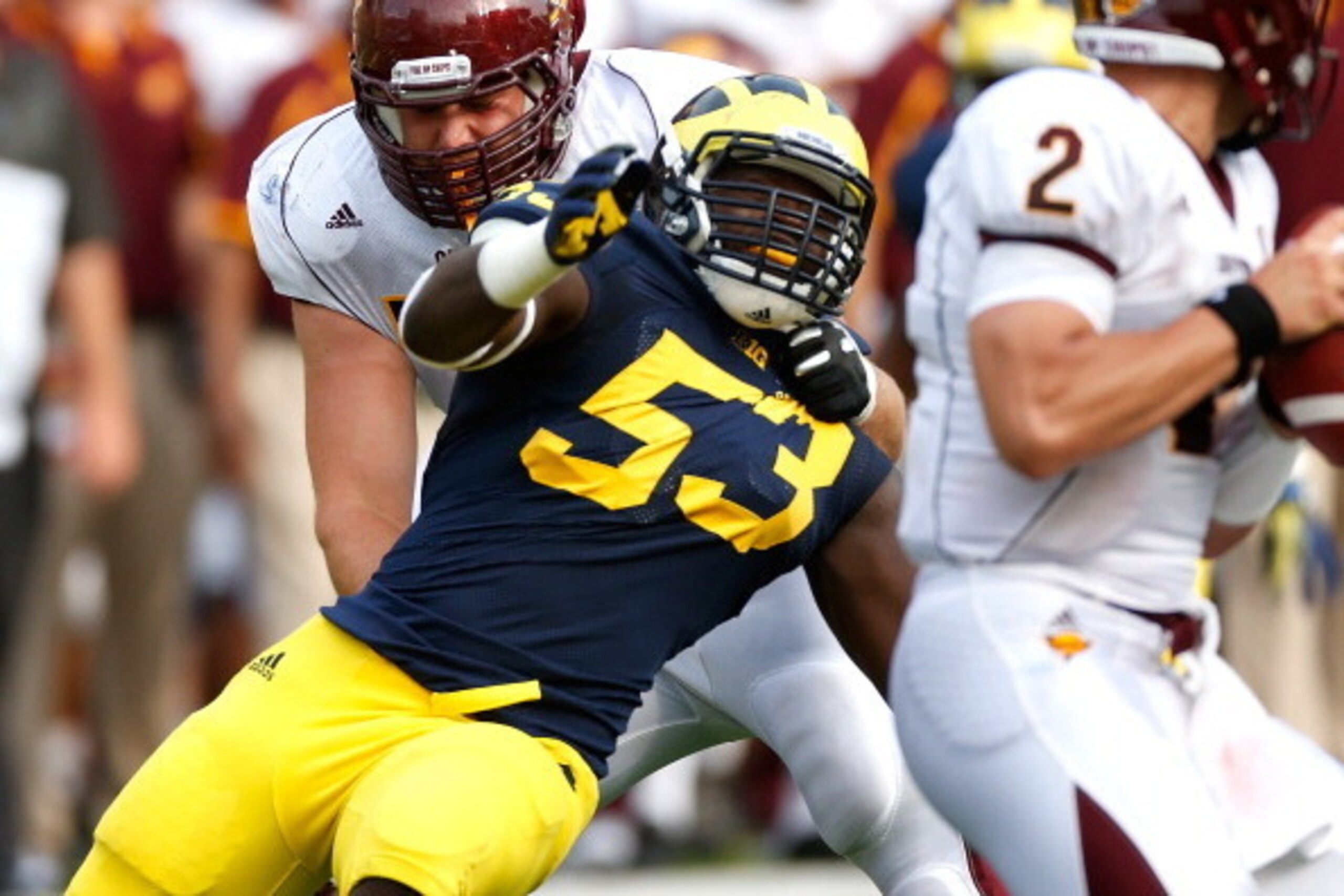ANN ARBOR, MI - AUGUST 31: Mario Ojemudia #53 of the Michigan Wolverines tries to get around the block of Jake Olson #73 of the Central Michigan Chippewas at Michigan Stadium on August 31, 2013 in Ann Arbor, Michigan. Michigan won the 59-9. (Photo by Greg