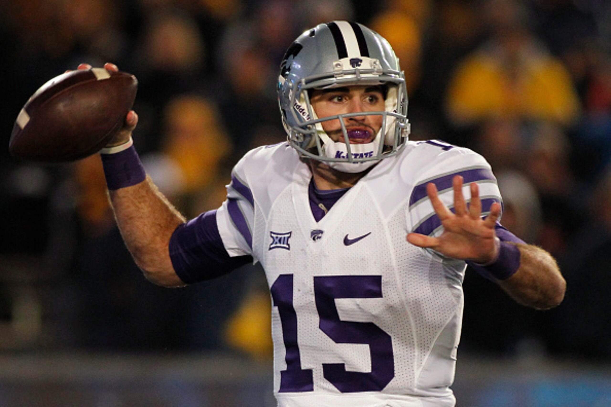 MORGANTOWN, WV - NOVEMBER 20:  Jake Waters #15 of the Kansas State Wildcats drops back to pass in the first half against the West Virginia Mountaineers during the game on November 20, 2014 at Mountaineer Field in Morgantown, West Virginia.  (Photo by Just