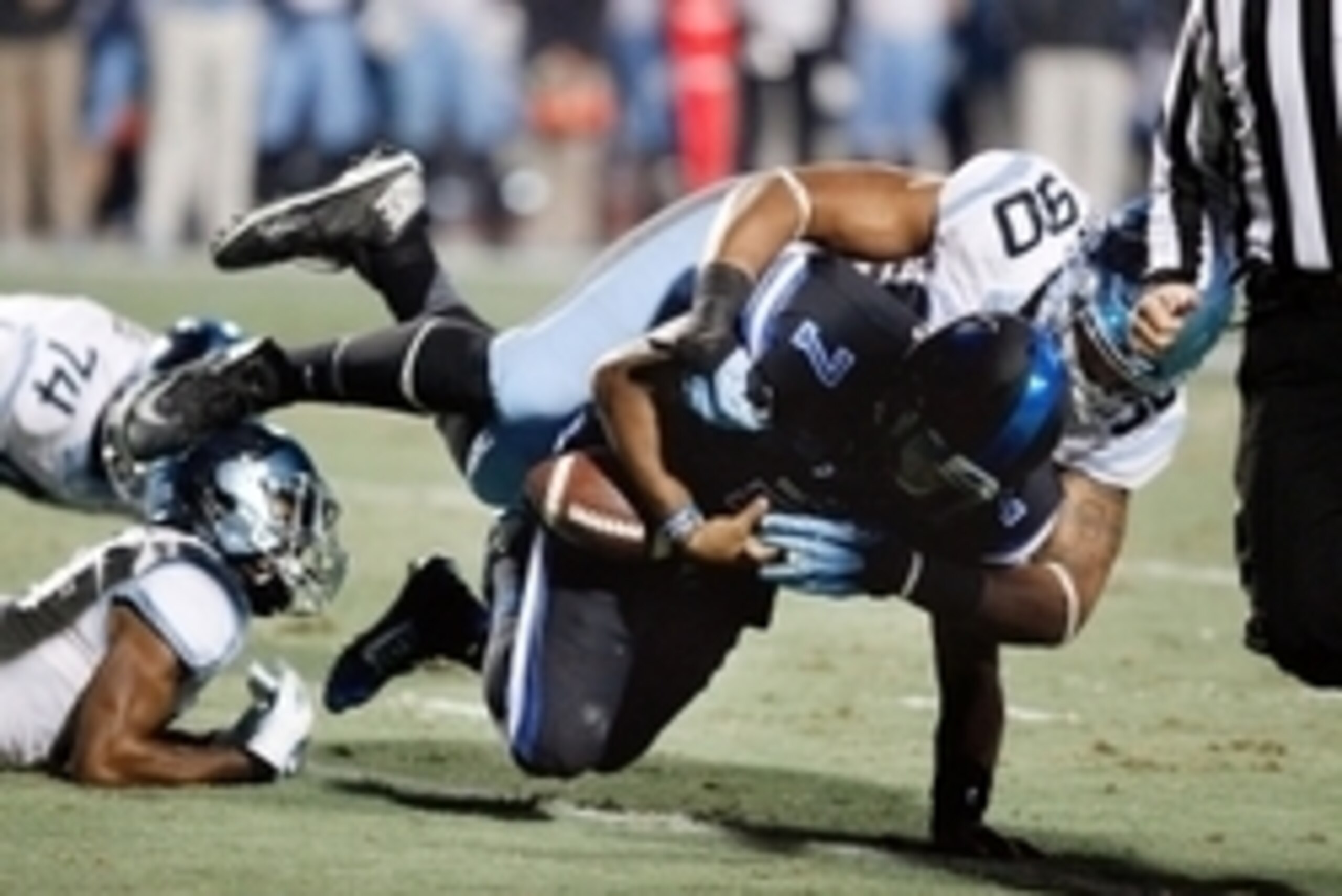 Nov 20, 2014; Durham, NC, USA; Duke Blue Devils quarterback Anthony Boone (7) fumbles the ball as he is tackled by North Carolina Tar Heels defensive tackle Nazair Jones (90) in their game at Wallace Wade Stadium. Mandatory Credit: Mark Dolejs-USA TODAY S
