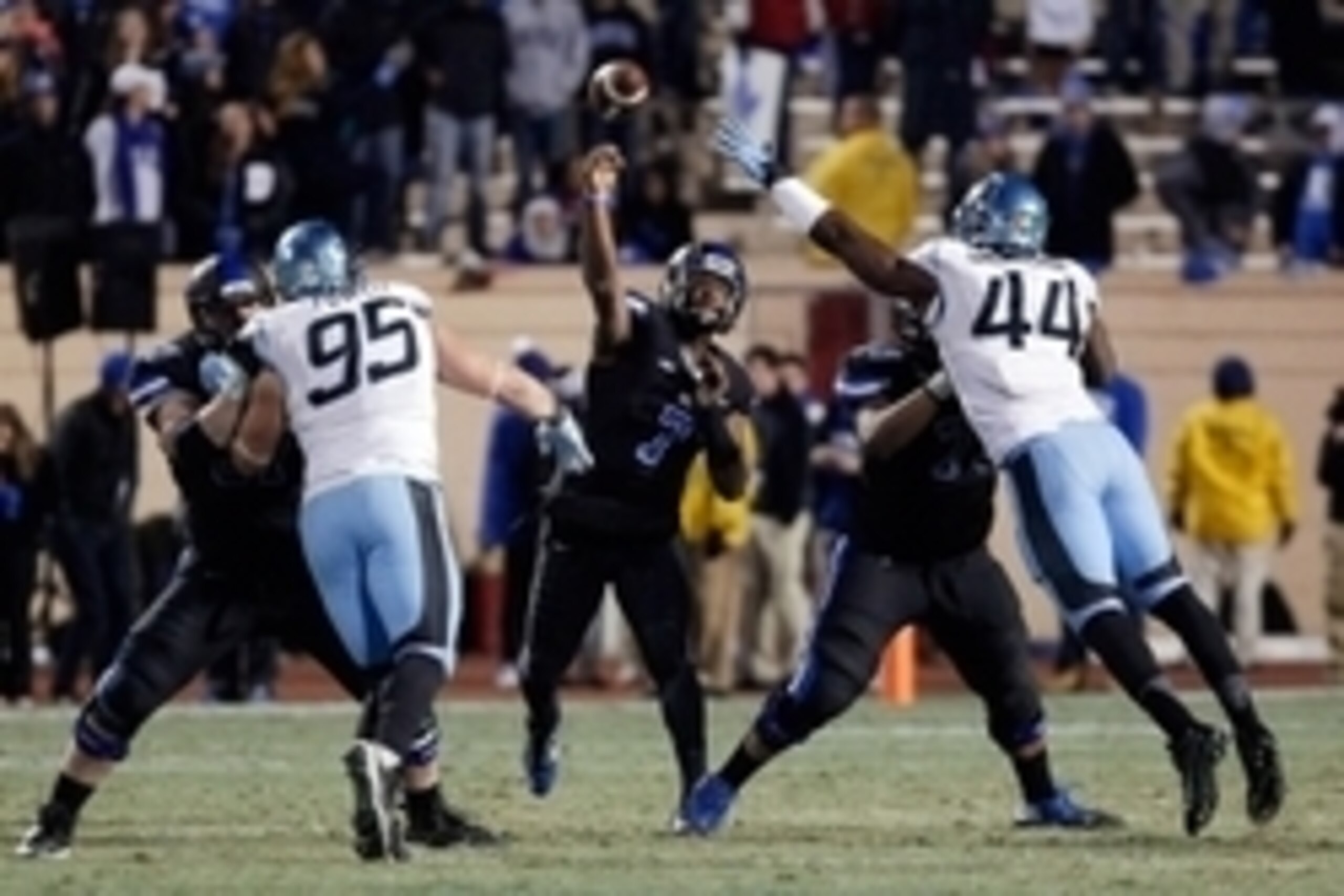Nov 20, 2014; Durham, NC, USA; Duke Blue Devils quarterback Anthony Boone (7) throws to a receiver as North Carolina Tar Heels defensive end Junior Gnonkonde (44) defends in their game at Wallace Wade Stadium. Mandatory Credit: Mark Dolejs-USA TODAY Sport