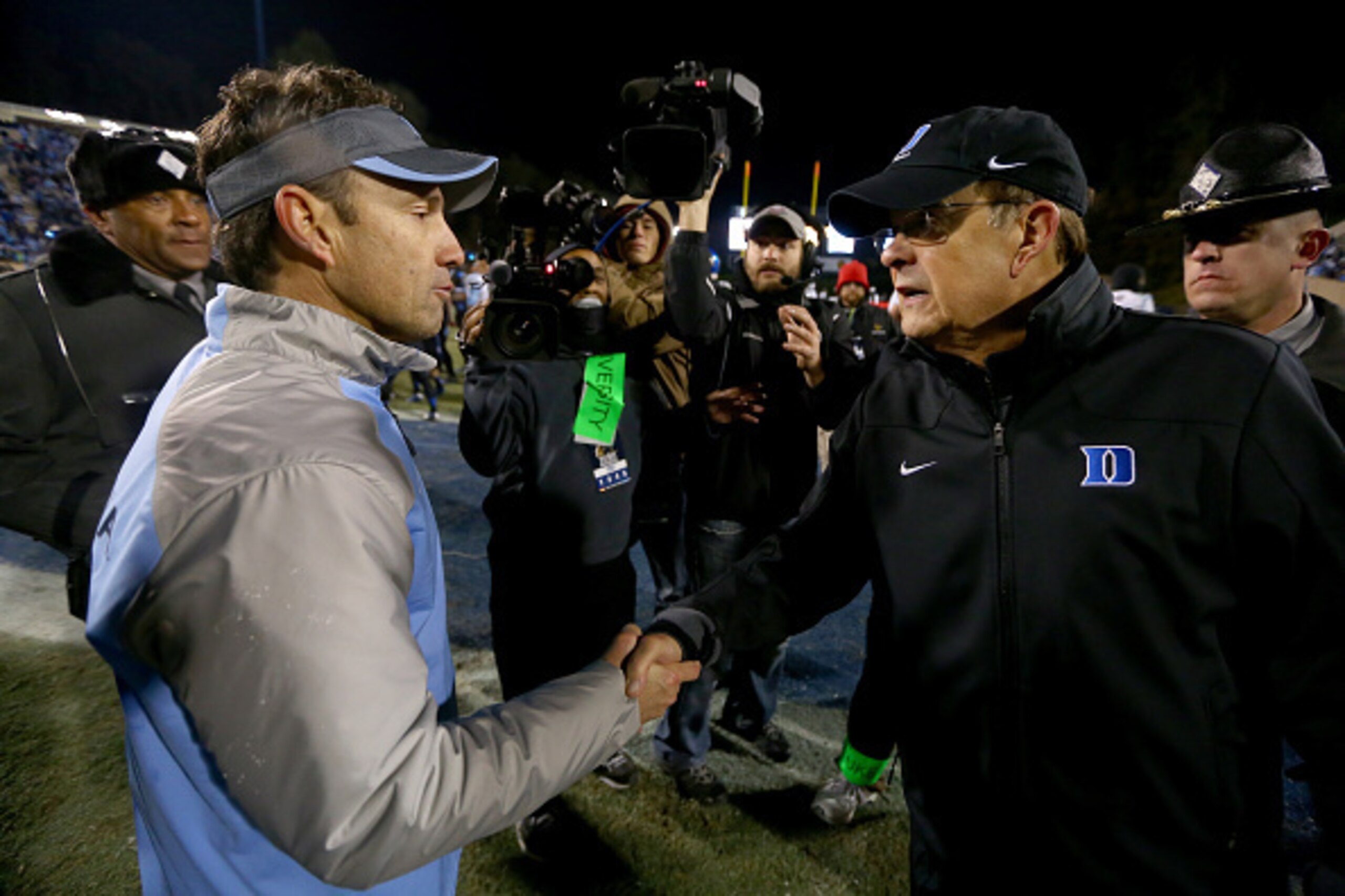 DURHAM, NC - NOVEMBER 20:  (L-R) Head coach Larry Fedora of the North Carolina Tar Heels shakes hands with head coach David Cutcliffe of the Duke Blue Devils after defeating the Blue Devils 45-20 at Wallace Wade Stadium on November 20, 2014 in Durham, Nor