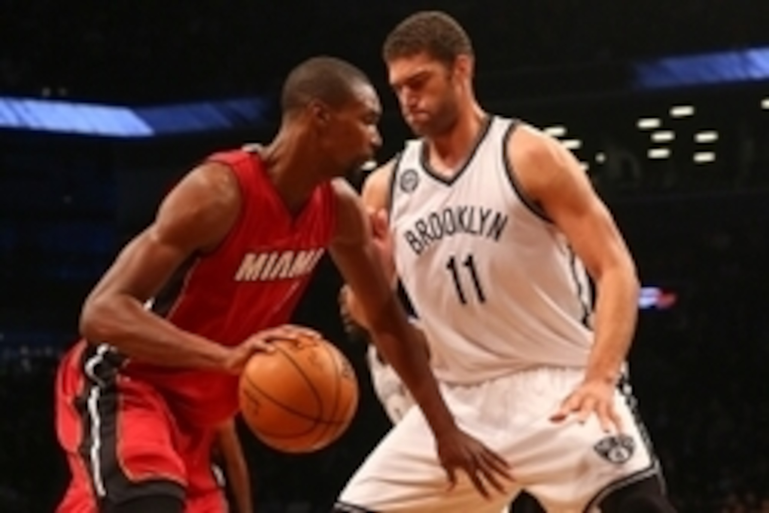 Nov 17, 2014; Brooklyn, NY, USA;  Miami Heat center Chris Bosh (1) drives past Brooklyn Nets center Brook Lopez (11) during the first quarter at Barclays Center. Mandatory Credit: Anthony Gruppuso-USA TODAY Sports