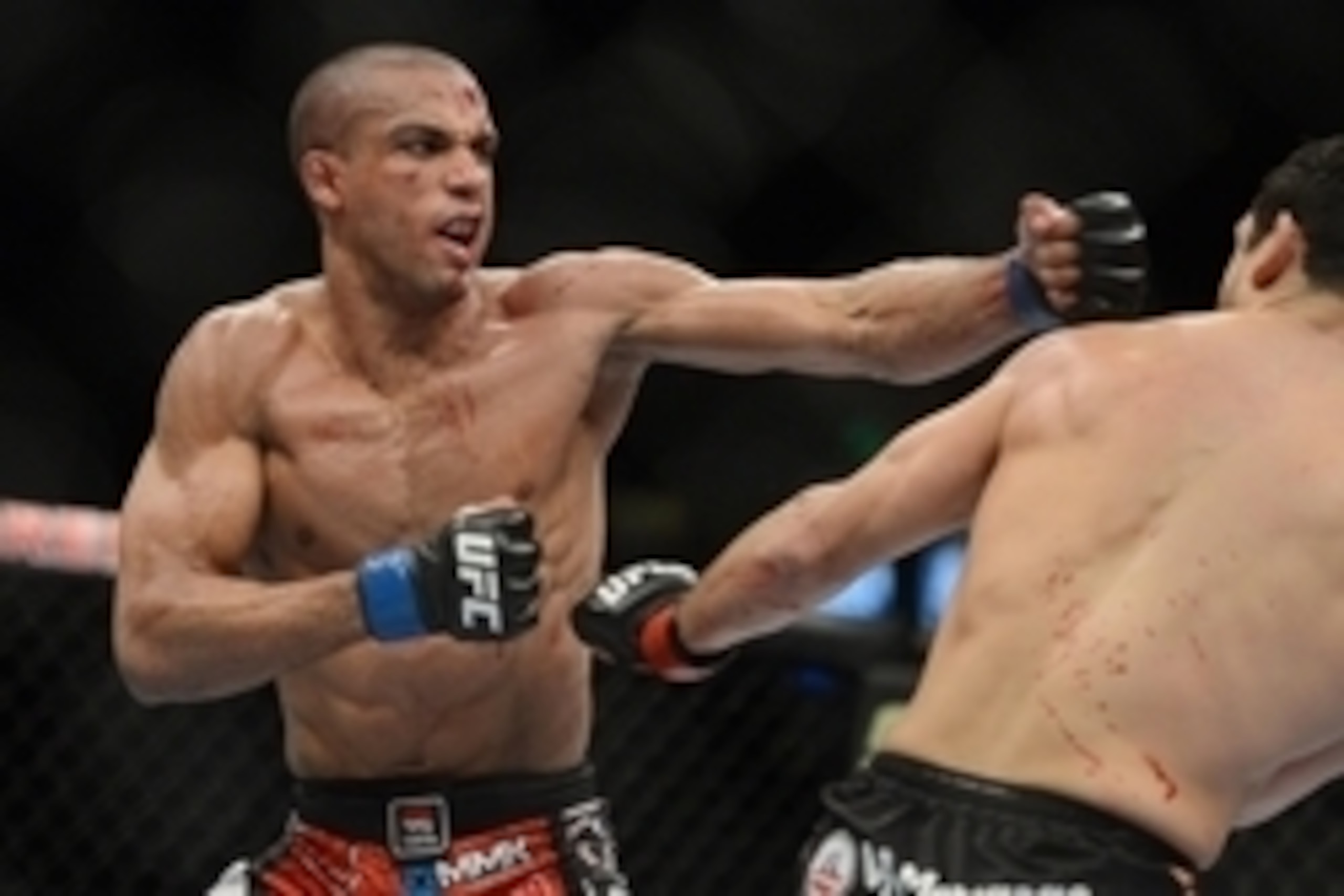 December 14, 2013; Sacramento, CA, USA; Danny Castillo (red gloves) fights Edson Barboza (blue gloves) during the lightweight bout of the UFC on FOX 9 at Sleep Train Arena. Mandatory Credit: Kyle Terada-USA TODAY Sports