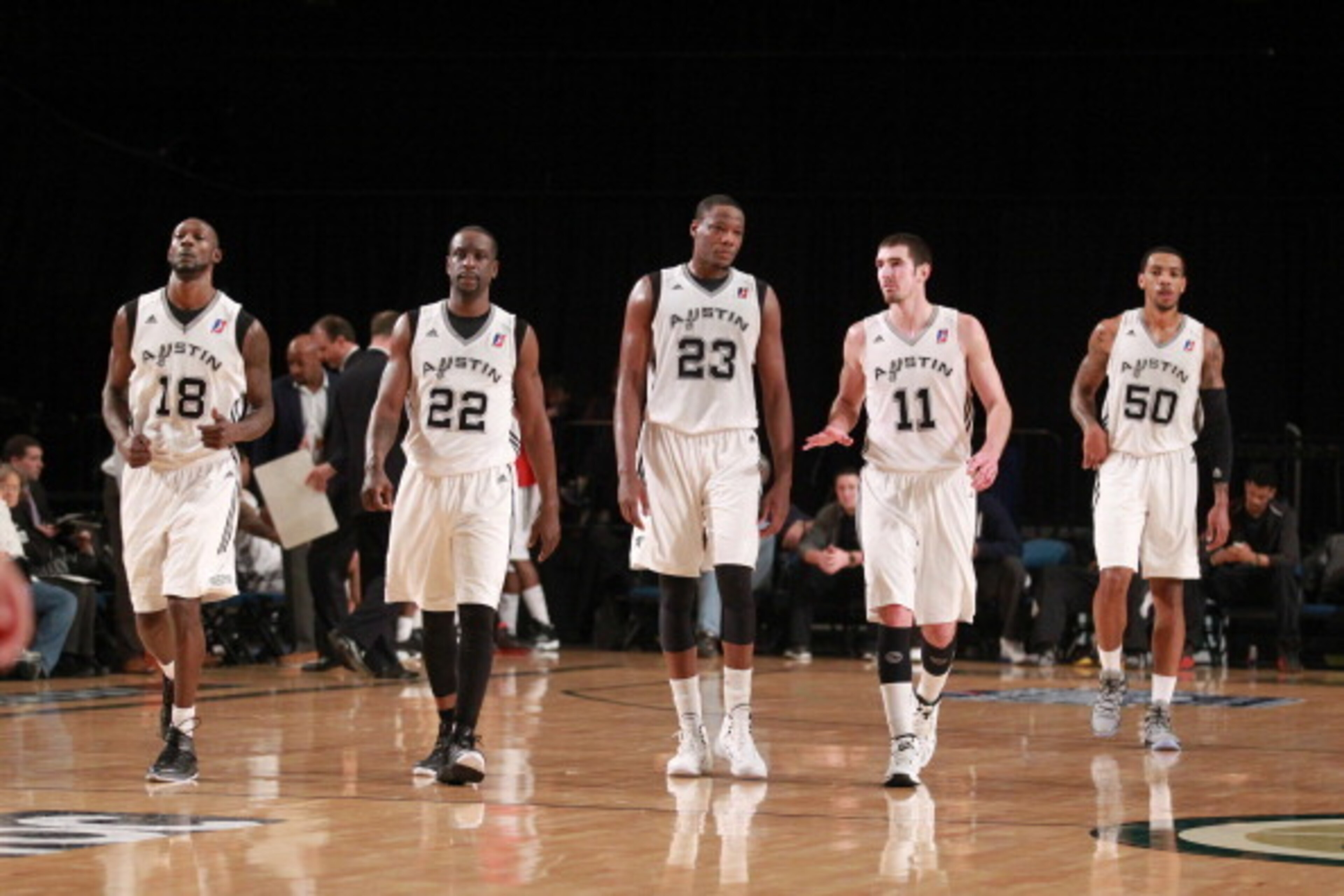 RENO - JANUARY 7: Courtney Fells #18, Flip Murry #22, Eric Dawson #23, Nando De Colo #11 and Malcolm Thomas #50 of the Austin Toros walk onto the kurt while playing against the Maine Red Claws during the 2014 NBA D-League Showcase presented by Samsung Ga RENO - JANUARY 7: Courtney Fells #18, Flip Murry #22, Eric Dawson #23, Nando De Colo #11 and Malcolm Thomas #50 of the Austin Toros walk onto the kurt while playing against the Maine Red Claws during the 2014 NBA D-League Showcase presented by Samsung Ga