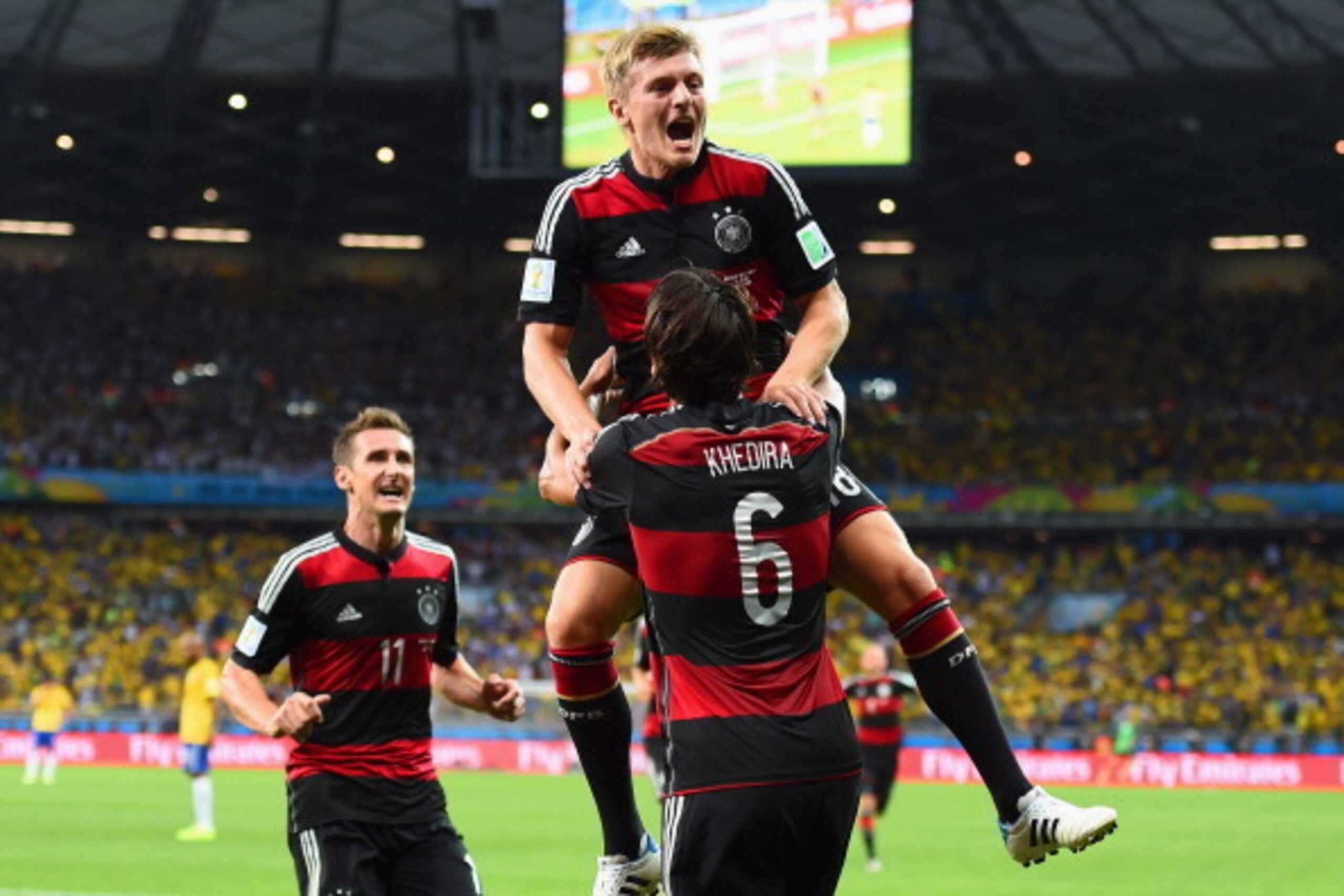BELO HORIZONTE, BRAZIL - JULY 08: Toni Kroos of Germany celebrates scoring his team's fourth goal with teammates Miroslav Klose (L) and Sami Khedira during the 2014 FIFA World Cup Brazil Semi Final match between Brazil and Germany at Estadio Mineirao on J