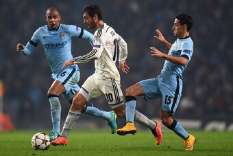 MANCHESTER, ENGLAND - NOVEMBER 05:  Alan Dzagoev of CSKA Moscow competes with Jesus Navas (R) and Fernando of Manchester City during the UEFA Champions League Group E match between Manchester City and CSKA Moscow on November 5, 2014 in Manchester, United 