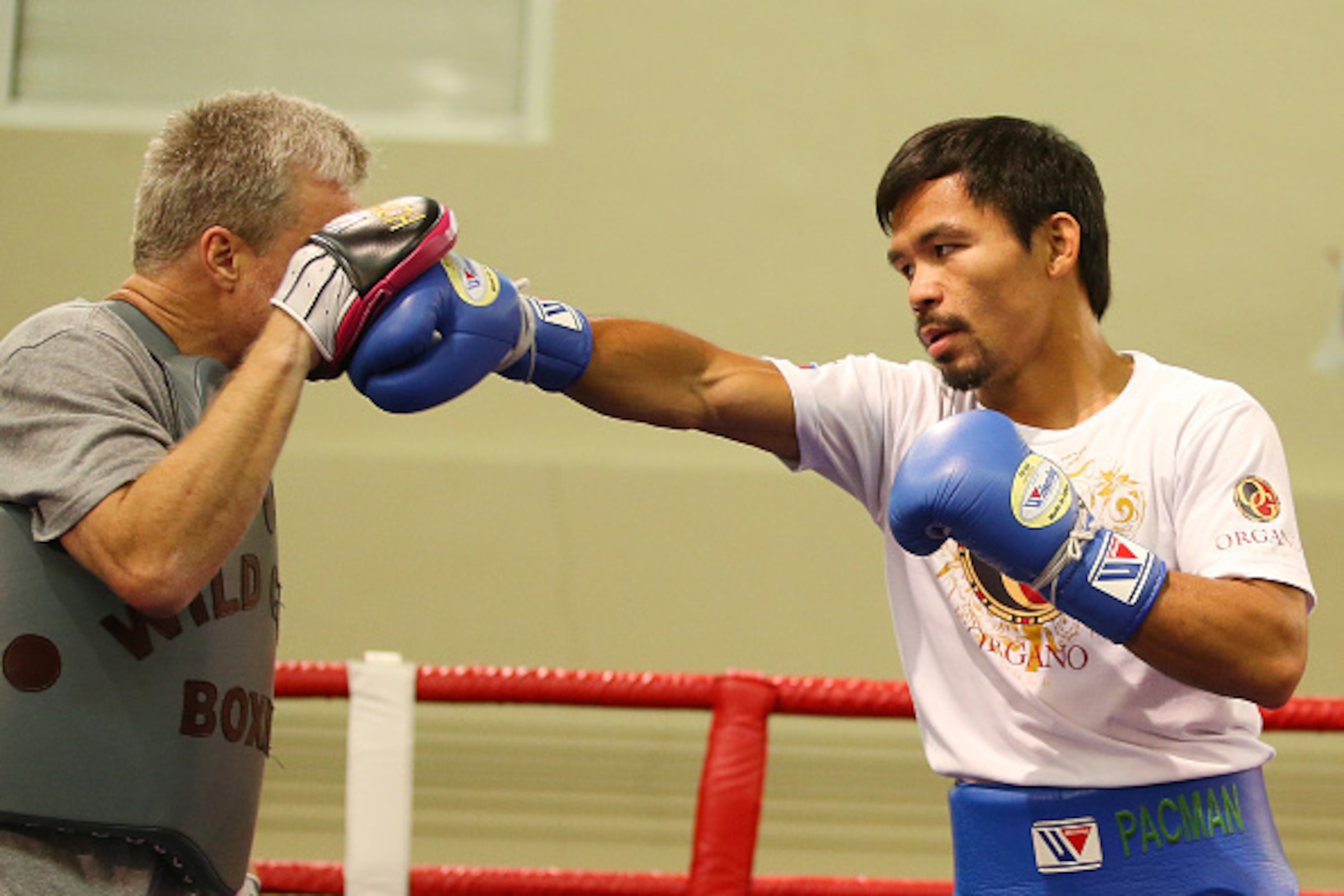 MACAU - NOVEMBER 21:  Manny Pacquiao works the mitts with trainer Freddie Roach during a workout session at The Venetianon November 21, 2014 in Macau, Macau.  (Photo by Chris Hyde/Getty Images)