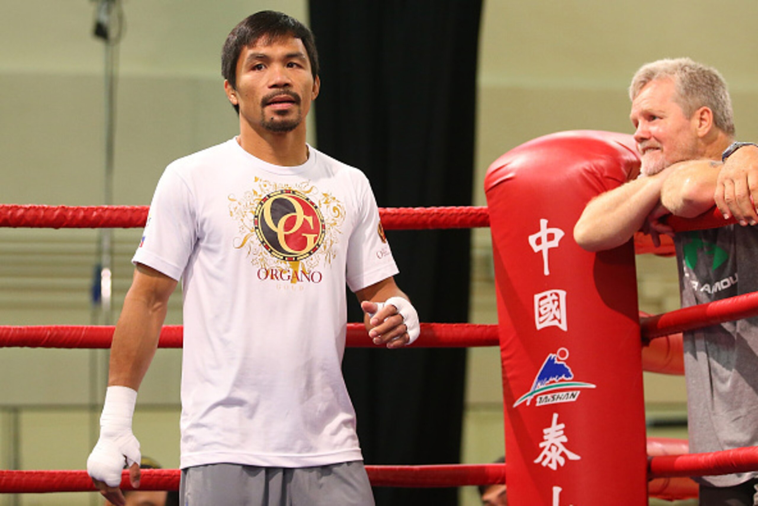 MACAU - NOVEMBER 21:  Manny Pacquiao trains while trainer Freddie Roach looks on during a workout session at The Venetianon November 21, 2014 in Macau, Macau.  (Photo by Chris Hyde/Getty Images)